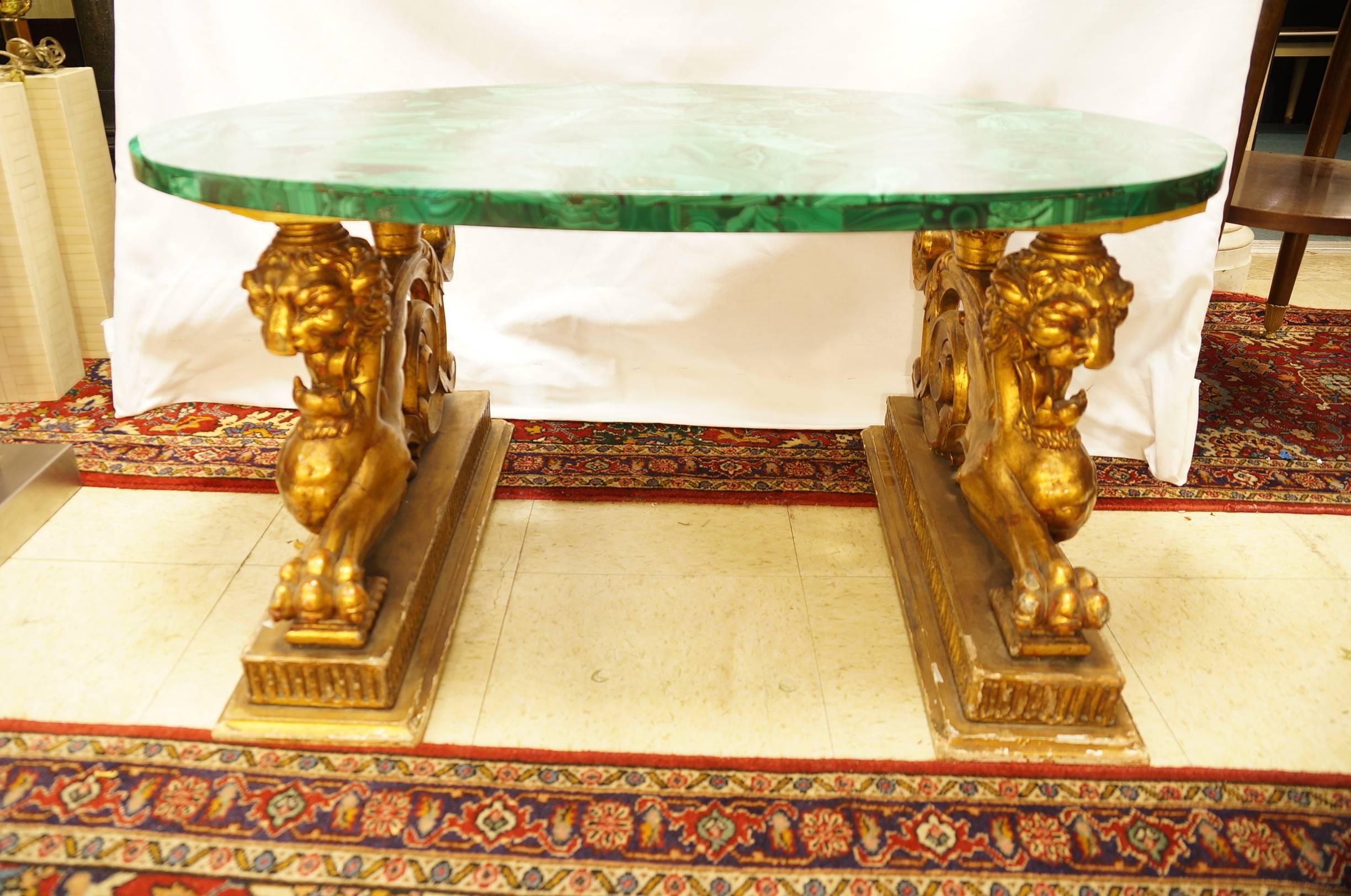 Magnificent green malachite low coffee table on a figural giltwood base.
Stock number: F47.