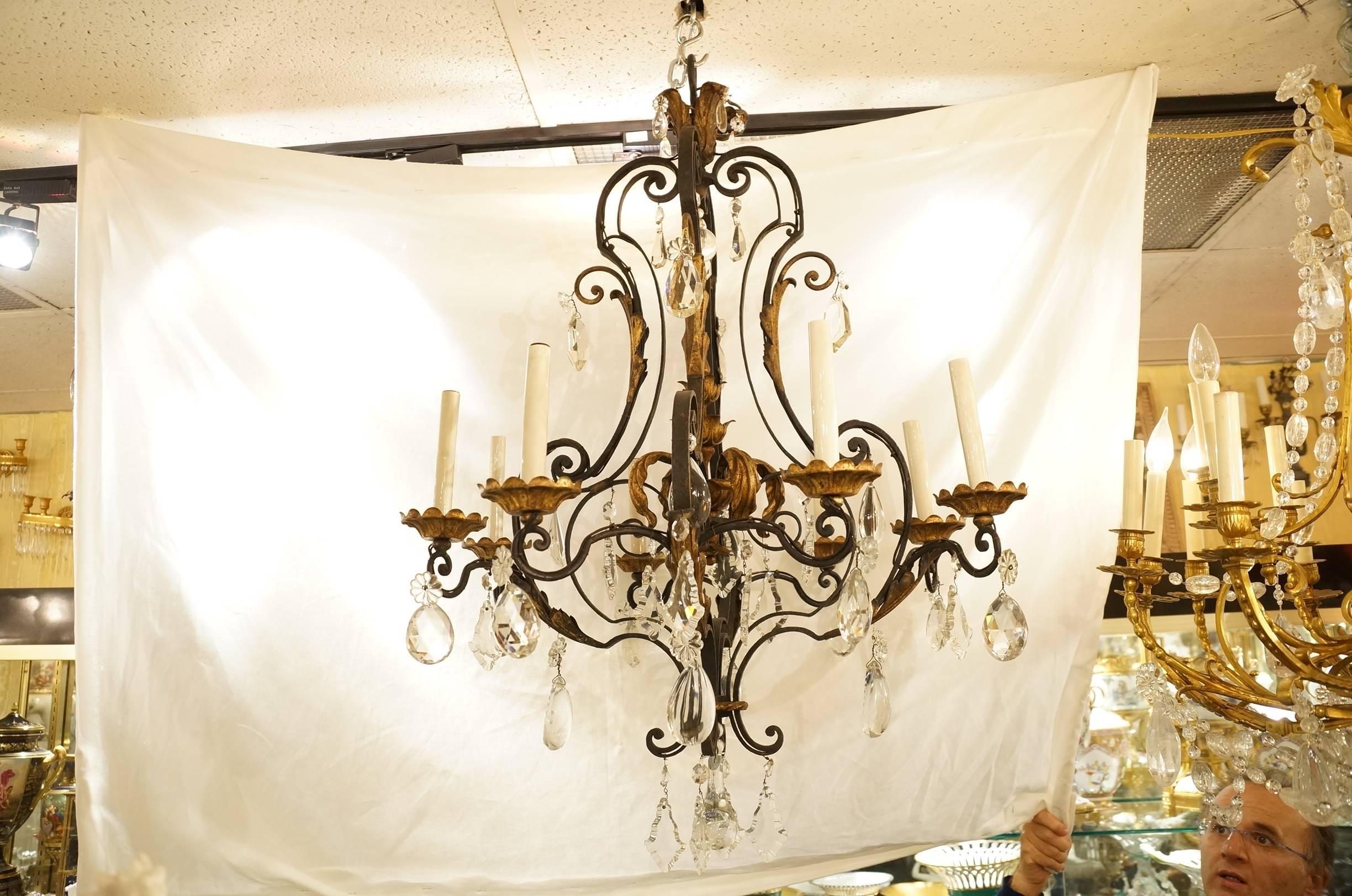 An eight-arm wrought iron and crystal chandelier with gilt highlights.
Stock Number: L428