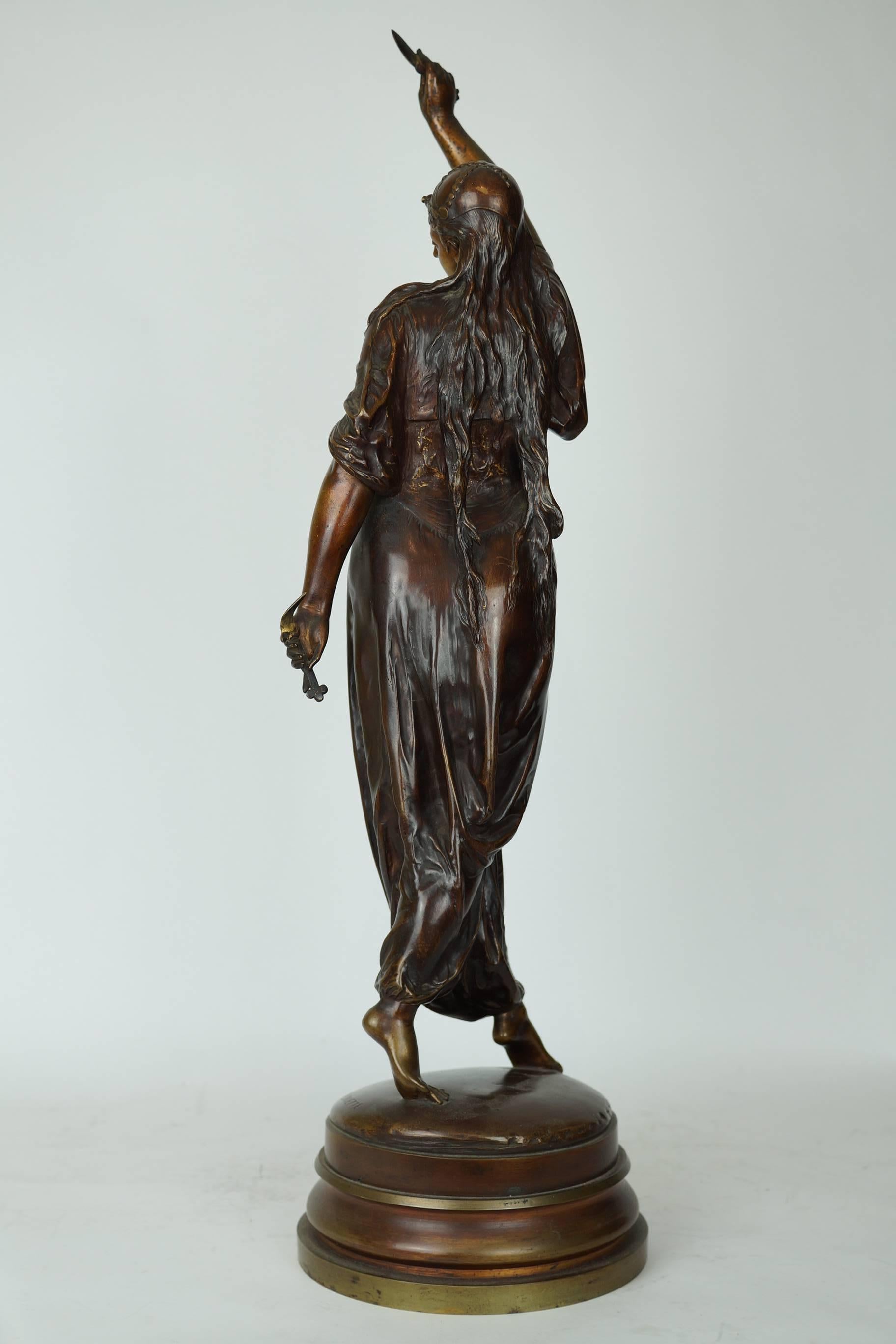 French, 19th century orientalist bronze Figure of standing Turkish woman dancer holding a knife in her hand with very elaborate jewelry around her neck. Signed Lalouette.