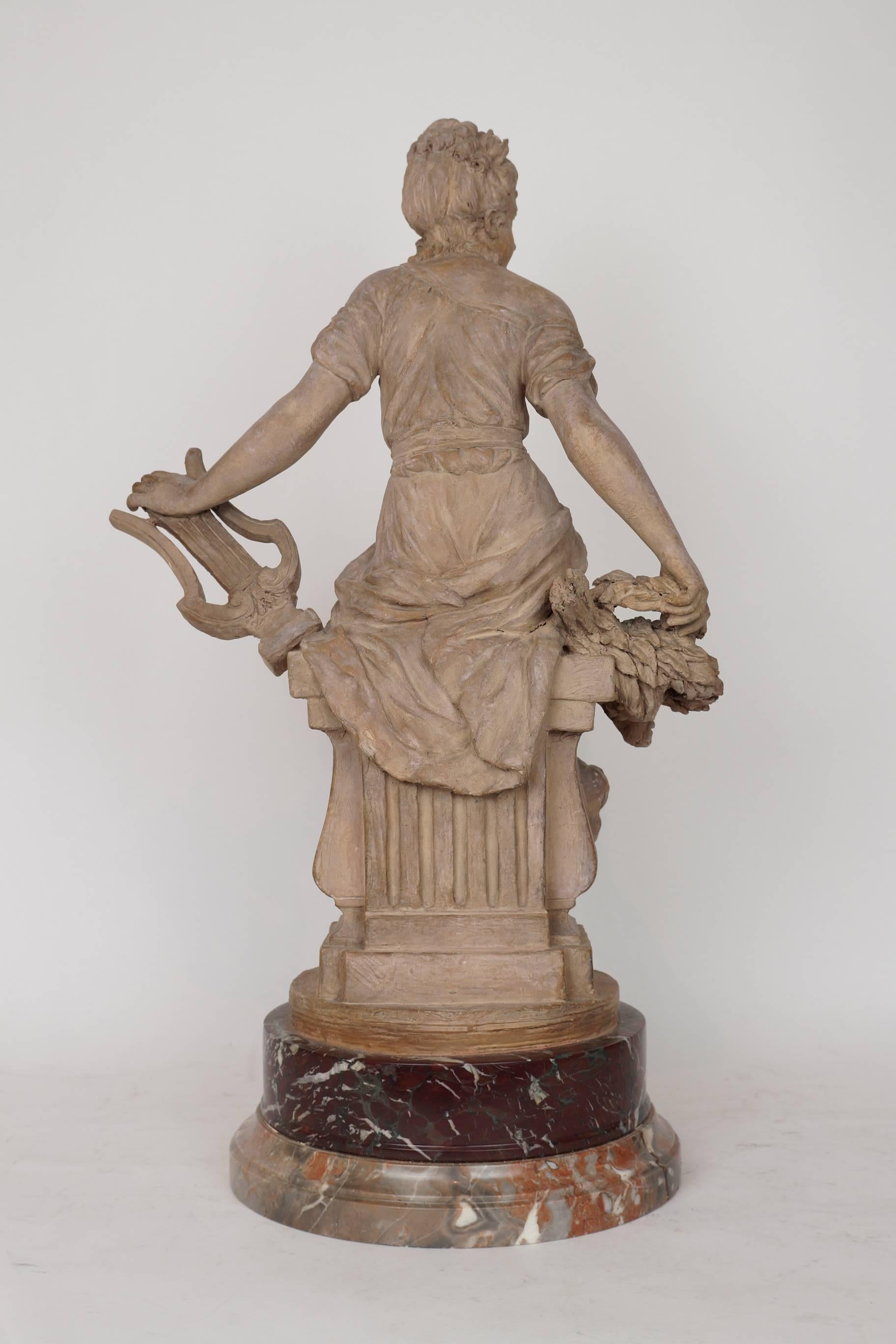 Fine terracotta figure of a seated woman holding musical instrument on round marble base.
Apparently unsigned.
Stock number: SC118