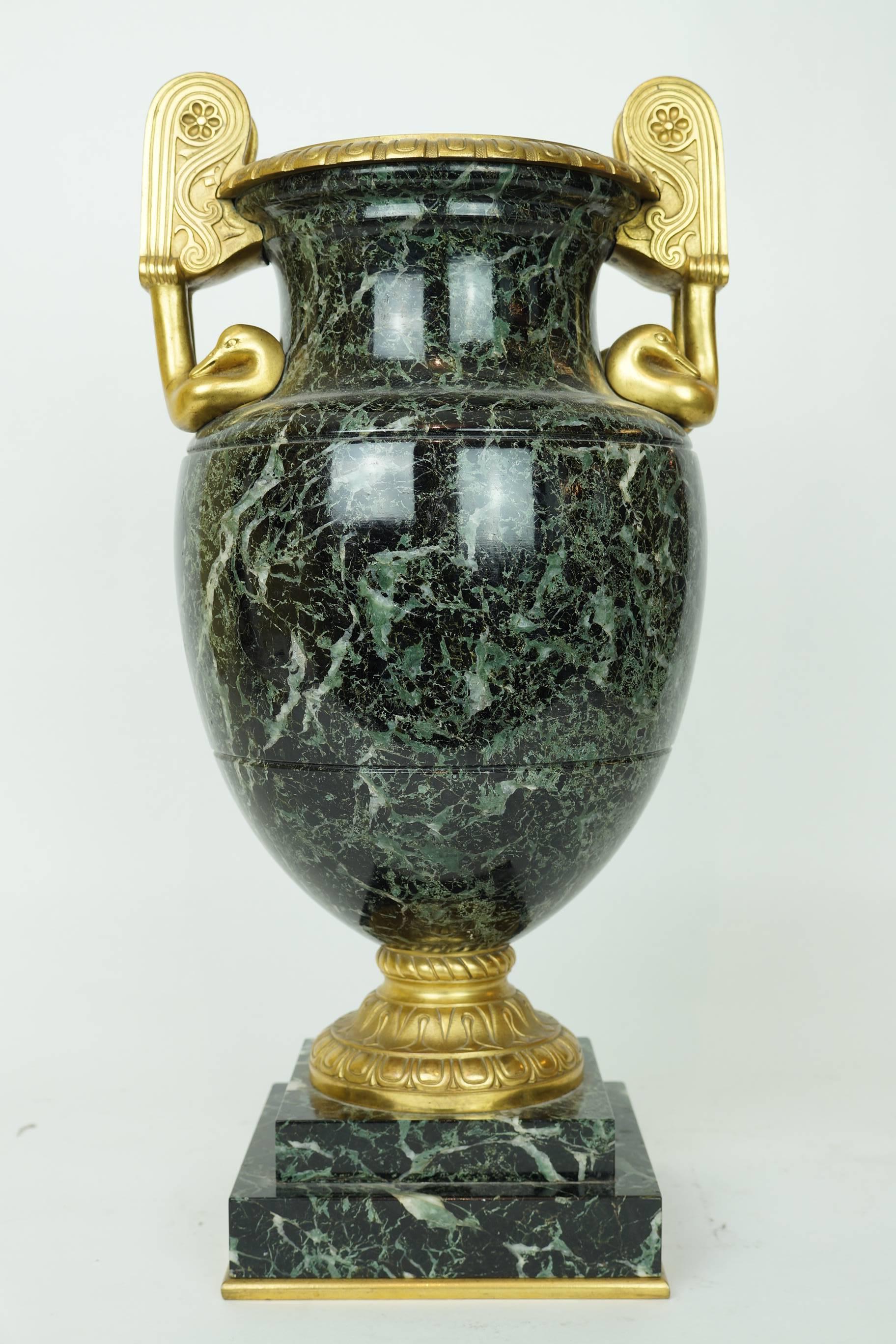 Pair of neoclassical marble and bronze urns with bronze swan handles.
Stock Number: DA148