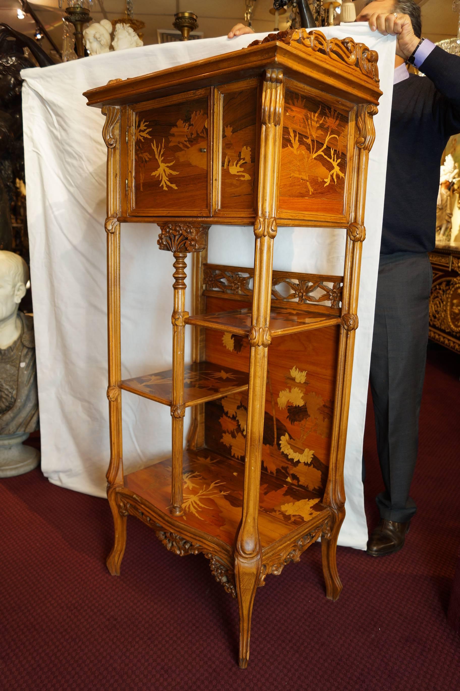 Magnificent pair of tall inlaid marquetry display cabinets with floral design
in the style of Louis Majorelle.
Stock Number: F63