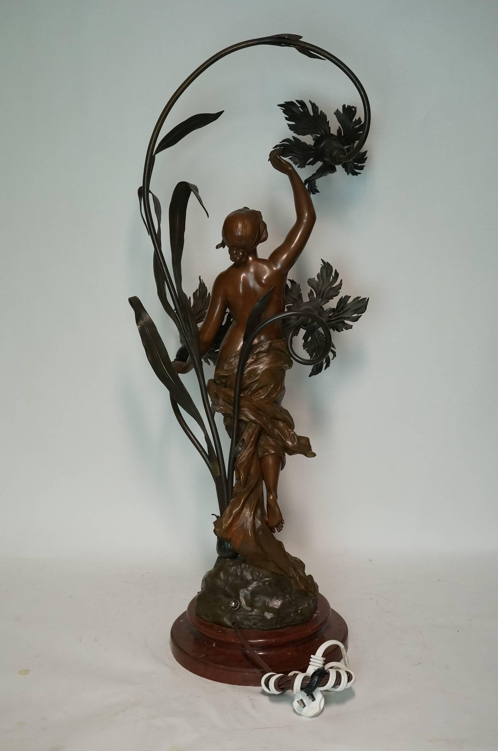 French 19 century Art Nouveau patinated bronze figural three-light table lamp on a rouge marble base .
Stock number: LL39.