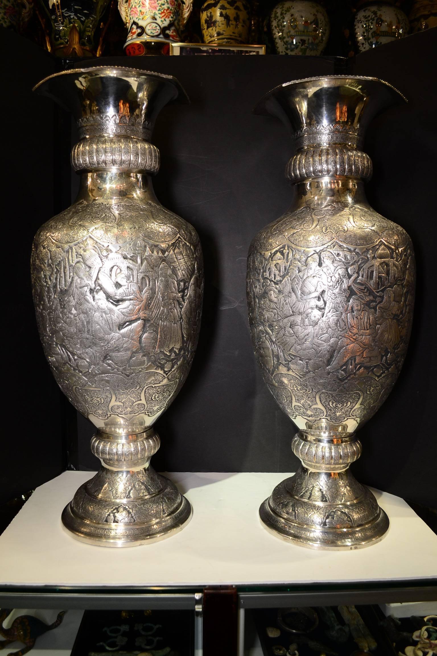 Magnificent pair of Persian silver palace size vases with inlaid figural work
Signed and stamped 84
This wonderful pair of palace size silver vases are rare for their quality of their work.
The artist has to use chisel and hammer to carve out