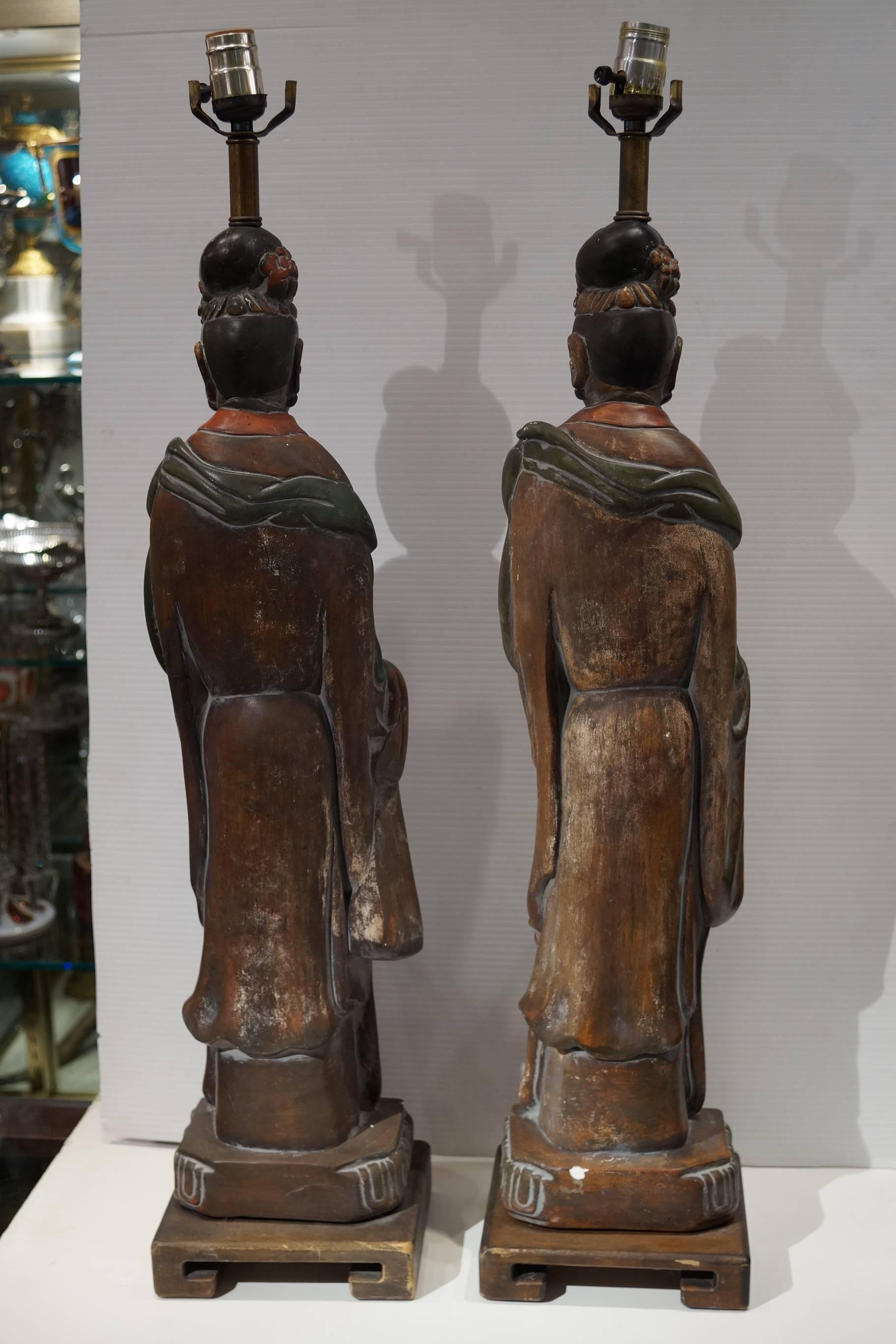 Pair of Chinese oriental figural table lamps on square wood base.