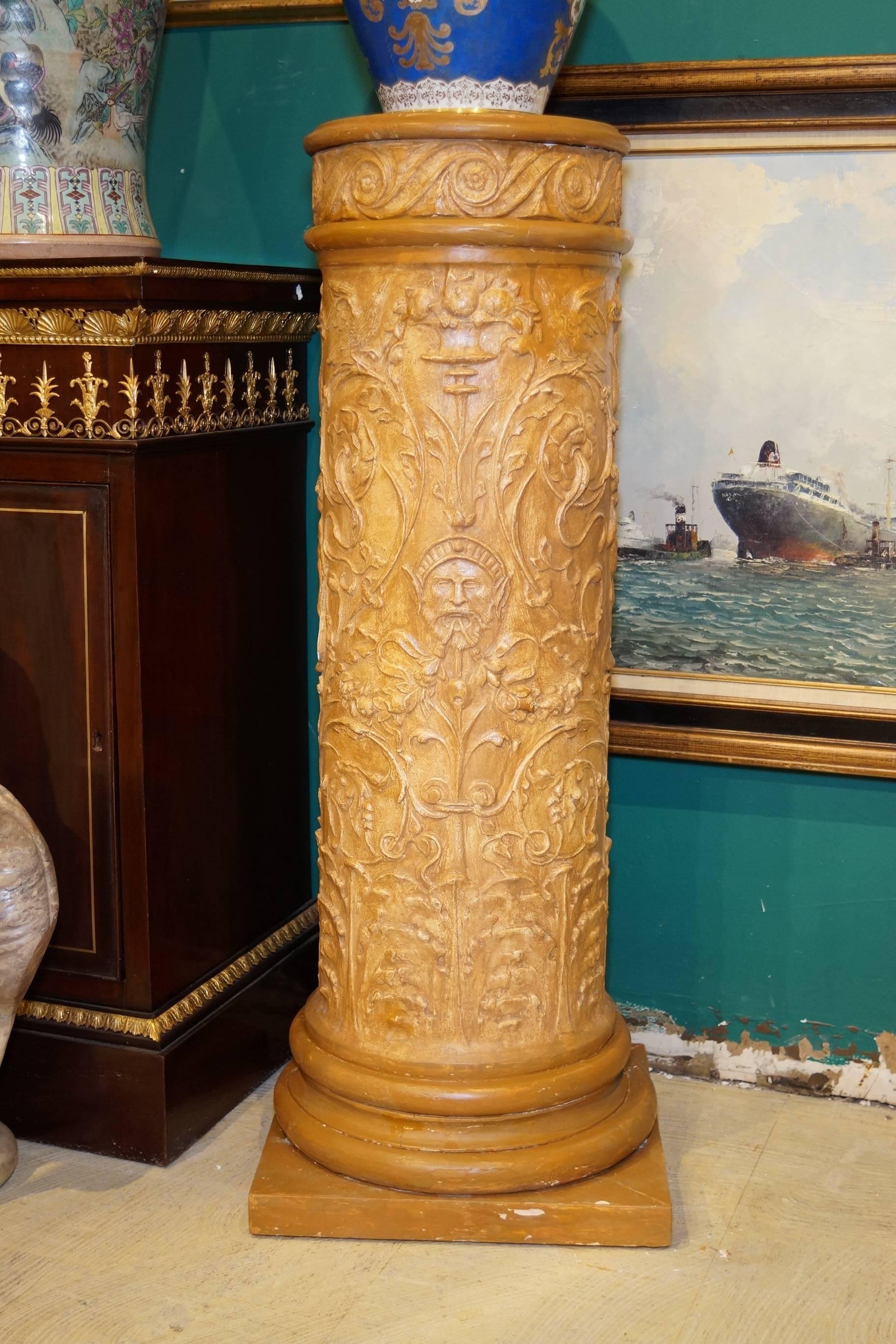 Set of four neoclassical gilt gesso pedestals with figural motif and leaf decorations.