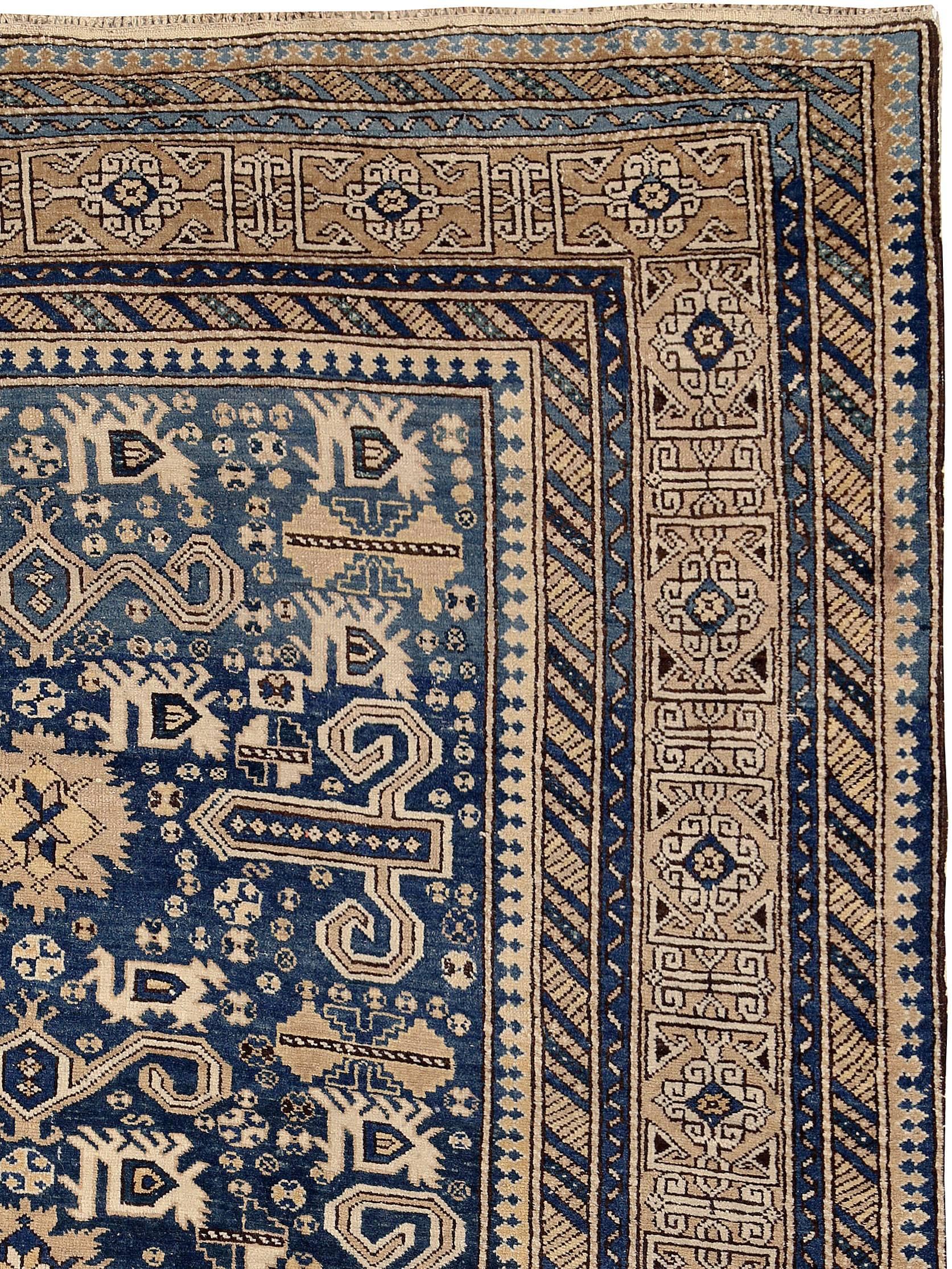 An antique Caucasian Perpedil carpet from the first quarter of the 20th century featuring its distinctive ram horn design.