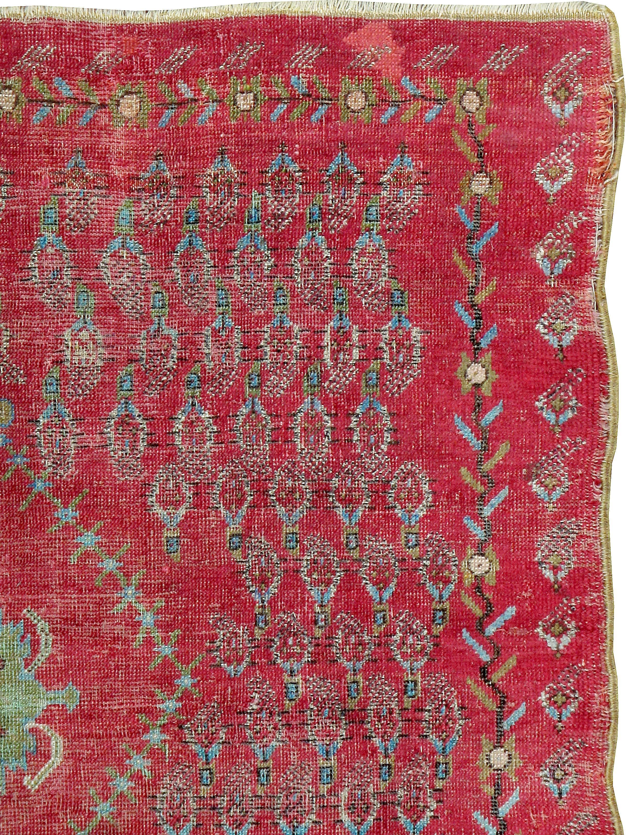 An antique Turkish Ghourdes (also spelled Ghiordes) carpet from the turn of the 20th century.