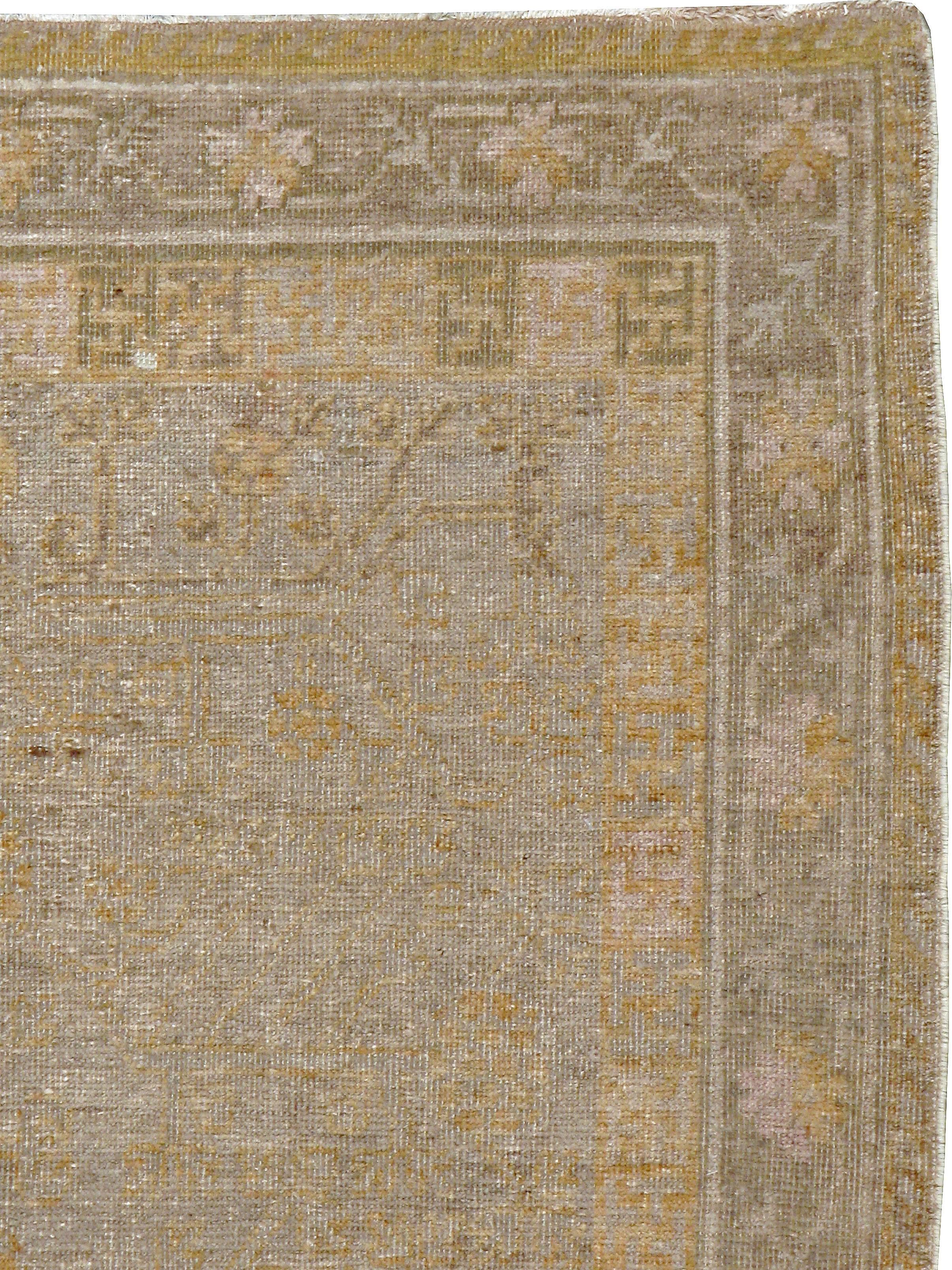 An antique East Turkestan Khotan carpet from the first quarter of the 20th century.