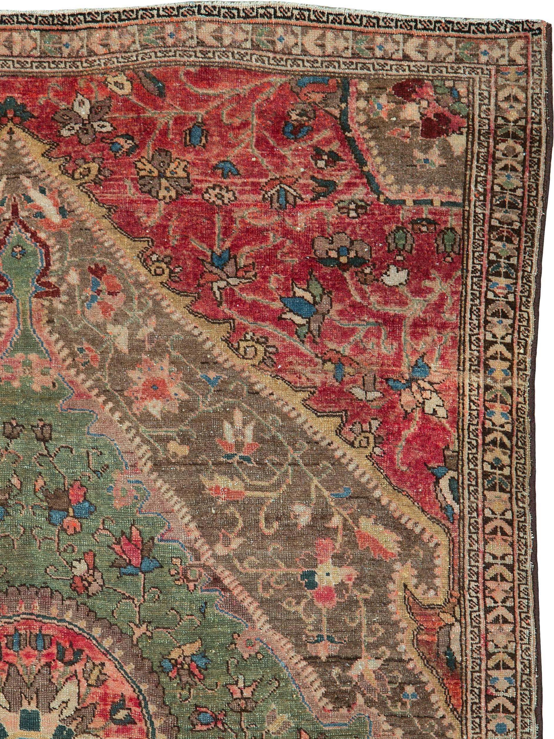 An antique Persian Sarouk Farahan (Feraghan) carpet from the turn of the 20th century.  The red in the field has been enhanced by going through an overdye process.