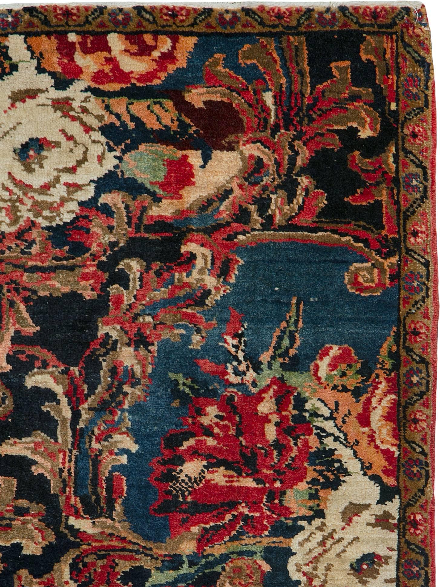 An antique Persian Bidjar carpet from the second quarter of the 20th century with a Gol Farang design which translates to 