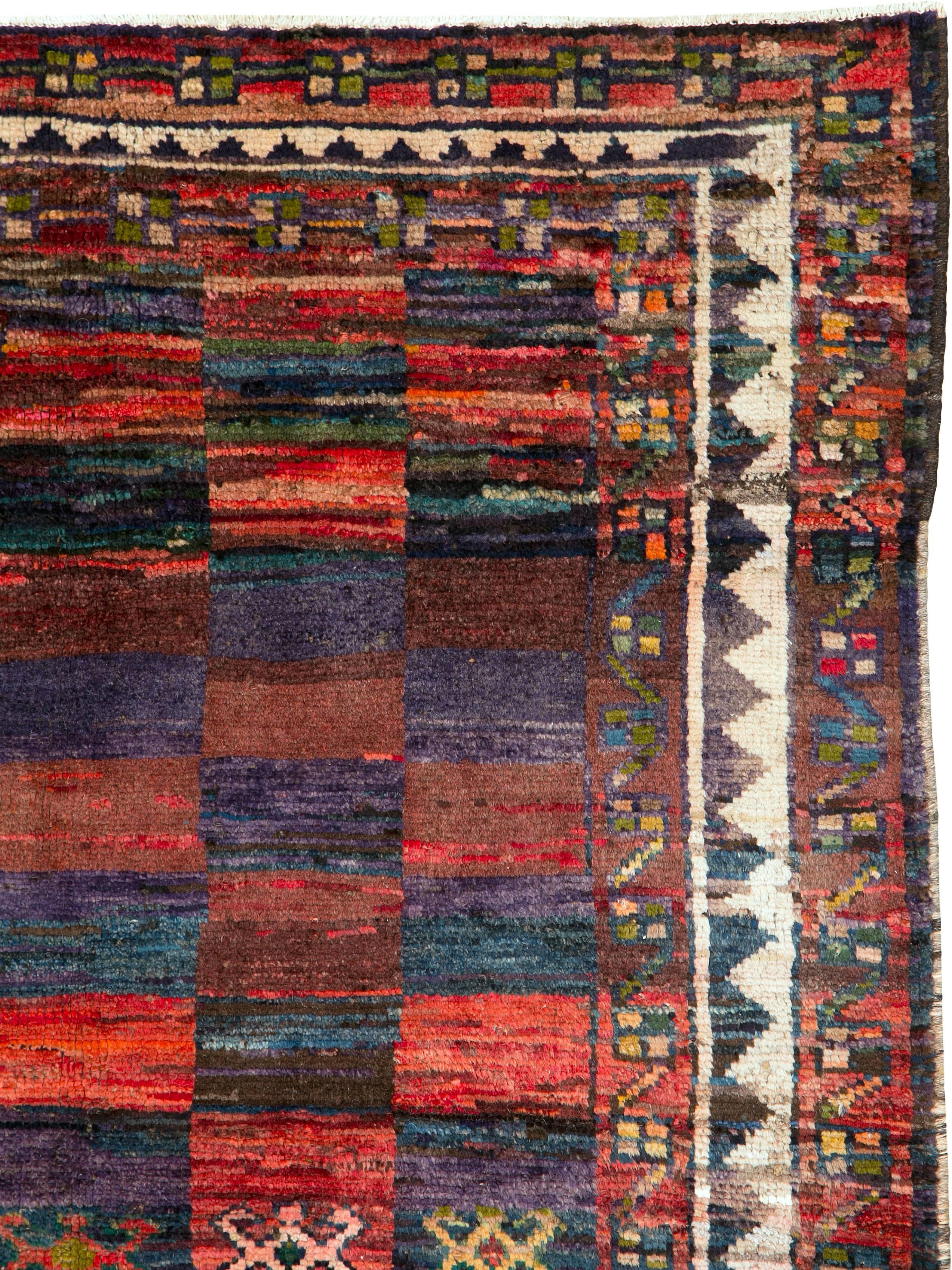 A vintage Persian gabbeh carpet from the mid-20th century.
