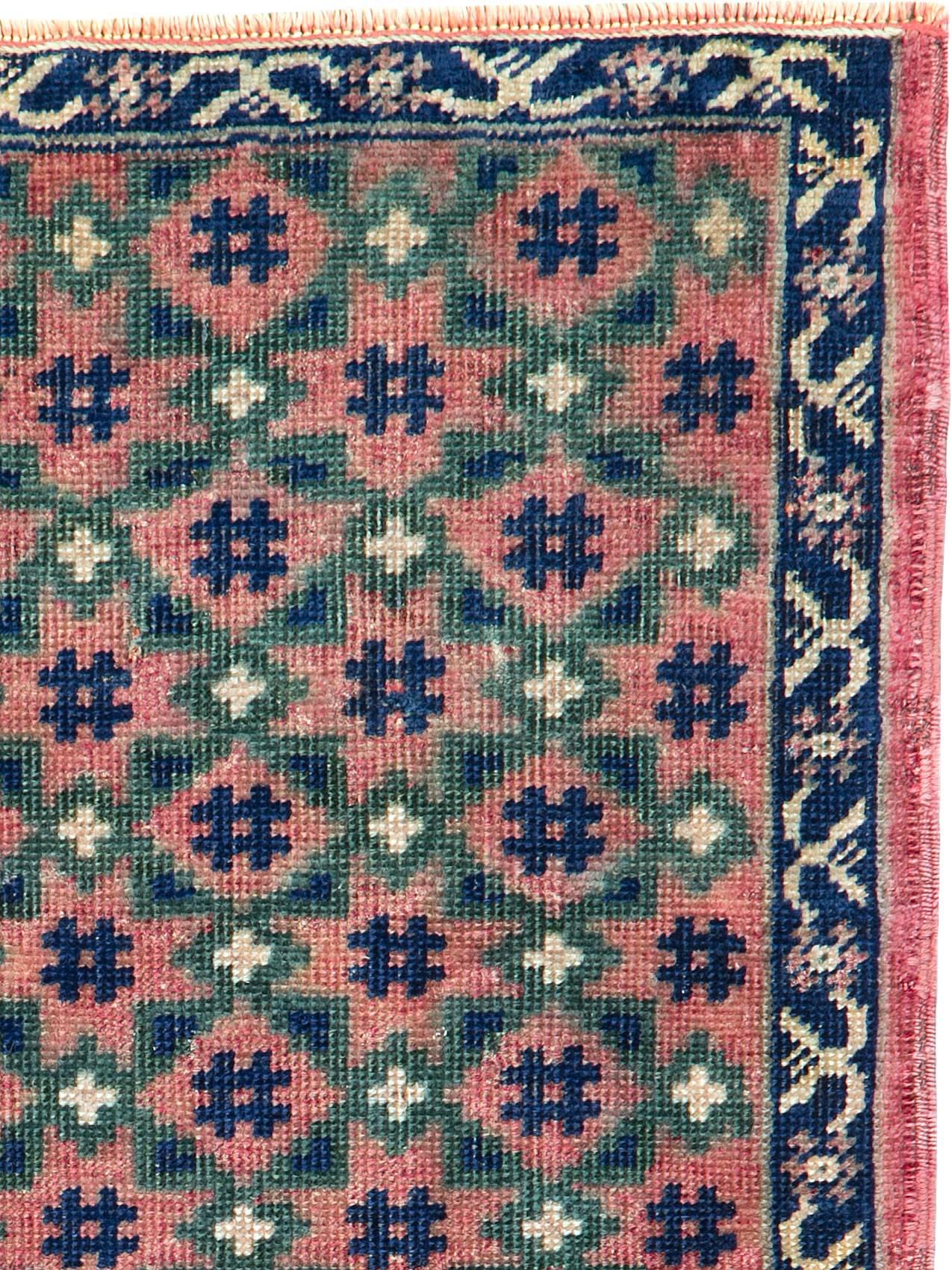 A vintage Persian Baluch carpet from the second quarter of the 20th century.
