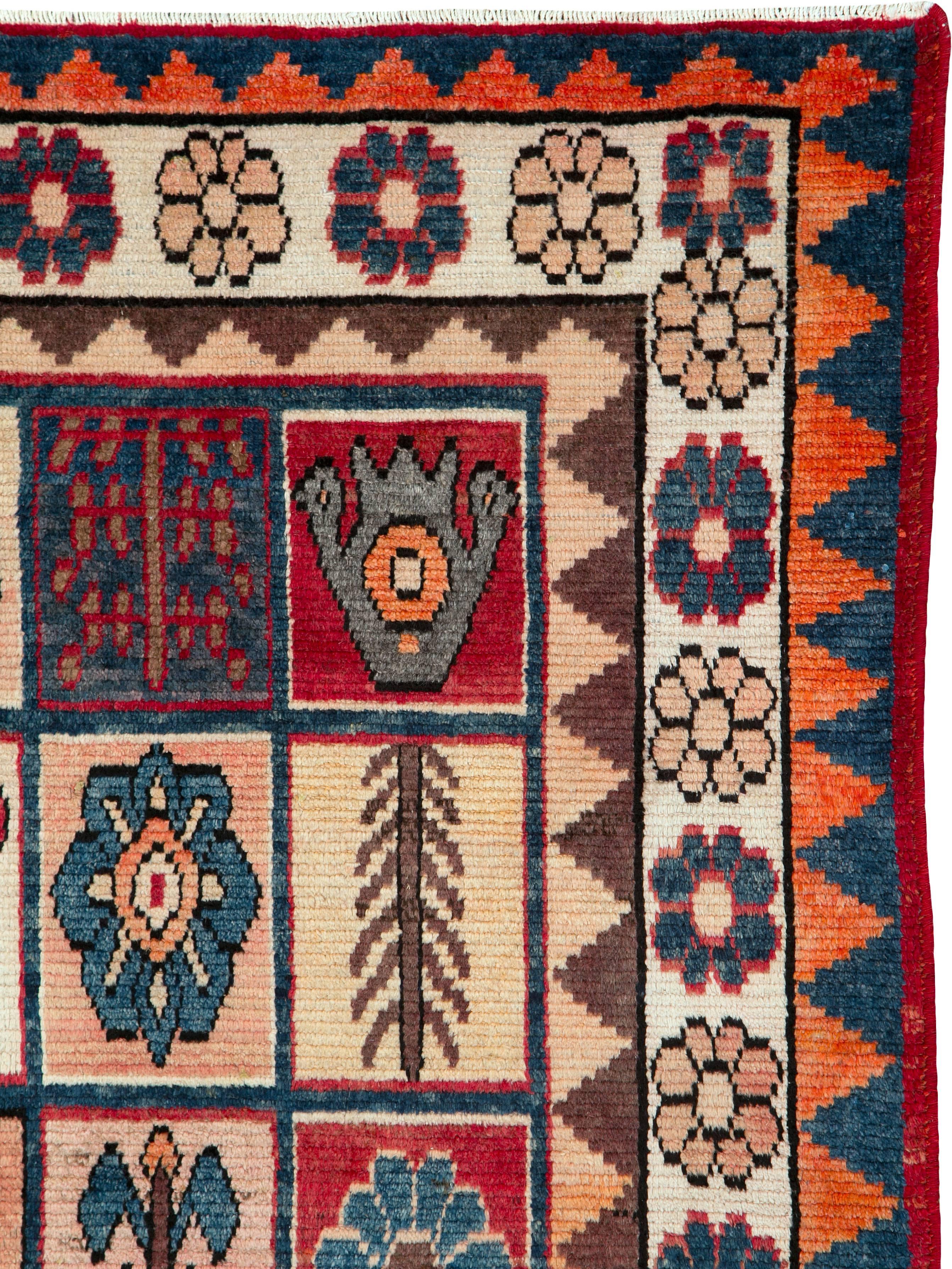 A vintage Persian Bakhtiari carpet from the second quarter of the 20th century with a garden design.