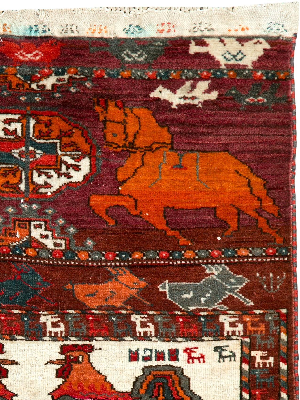 A vintage Persian Turkoman (Turkmen) carpet from the third quarter of the 20th century with a pictorial design.