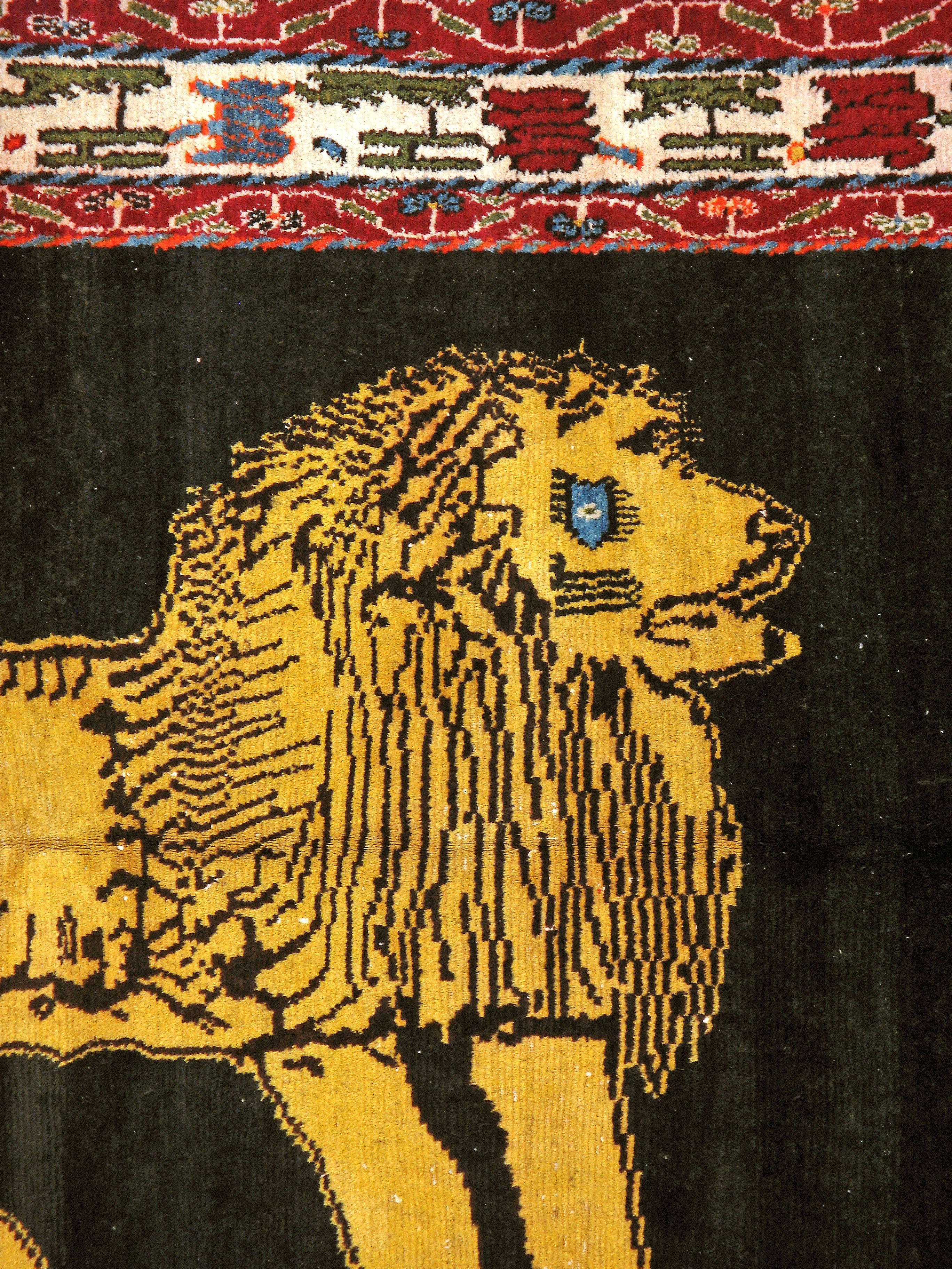 A vintage Persian Gabbeh carpet from the mid-20th century with a pictorial design of a lion.
