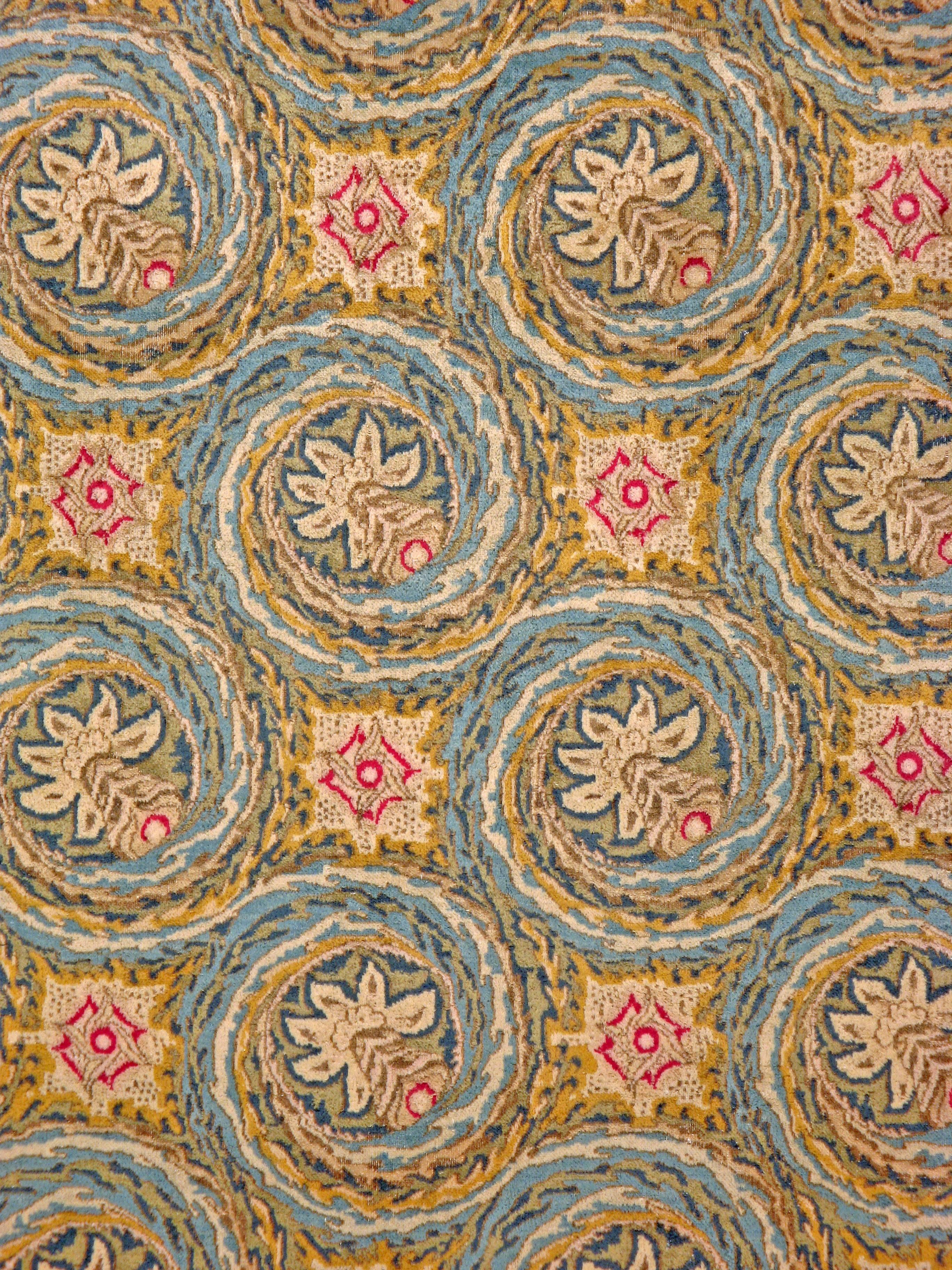 A vintage Persian Kerman carpet from the mid-20th century featuring a 'gol farang (foreign flower)' motif encompassed in a spiral brushstroke motif.