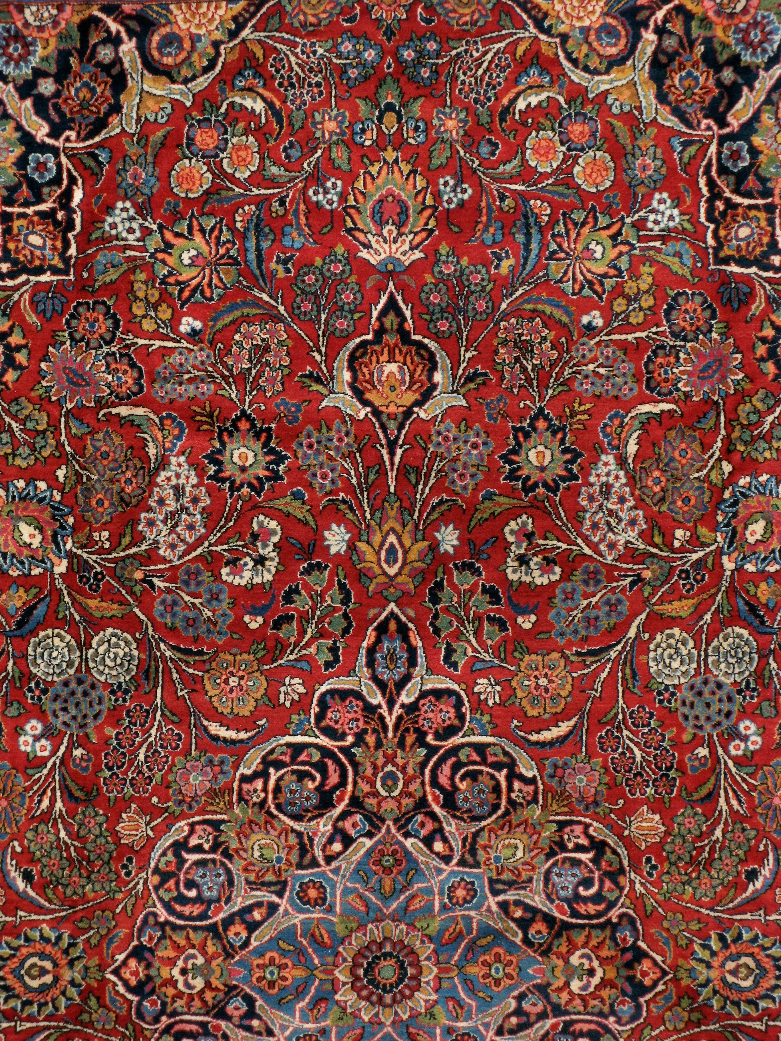 A vintage Persian Kashan room size rug handmade during the mid-20th century with a very traditional navy blue medallion, red field, and navy blue main border.

Measures: 8' 11