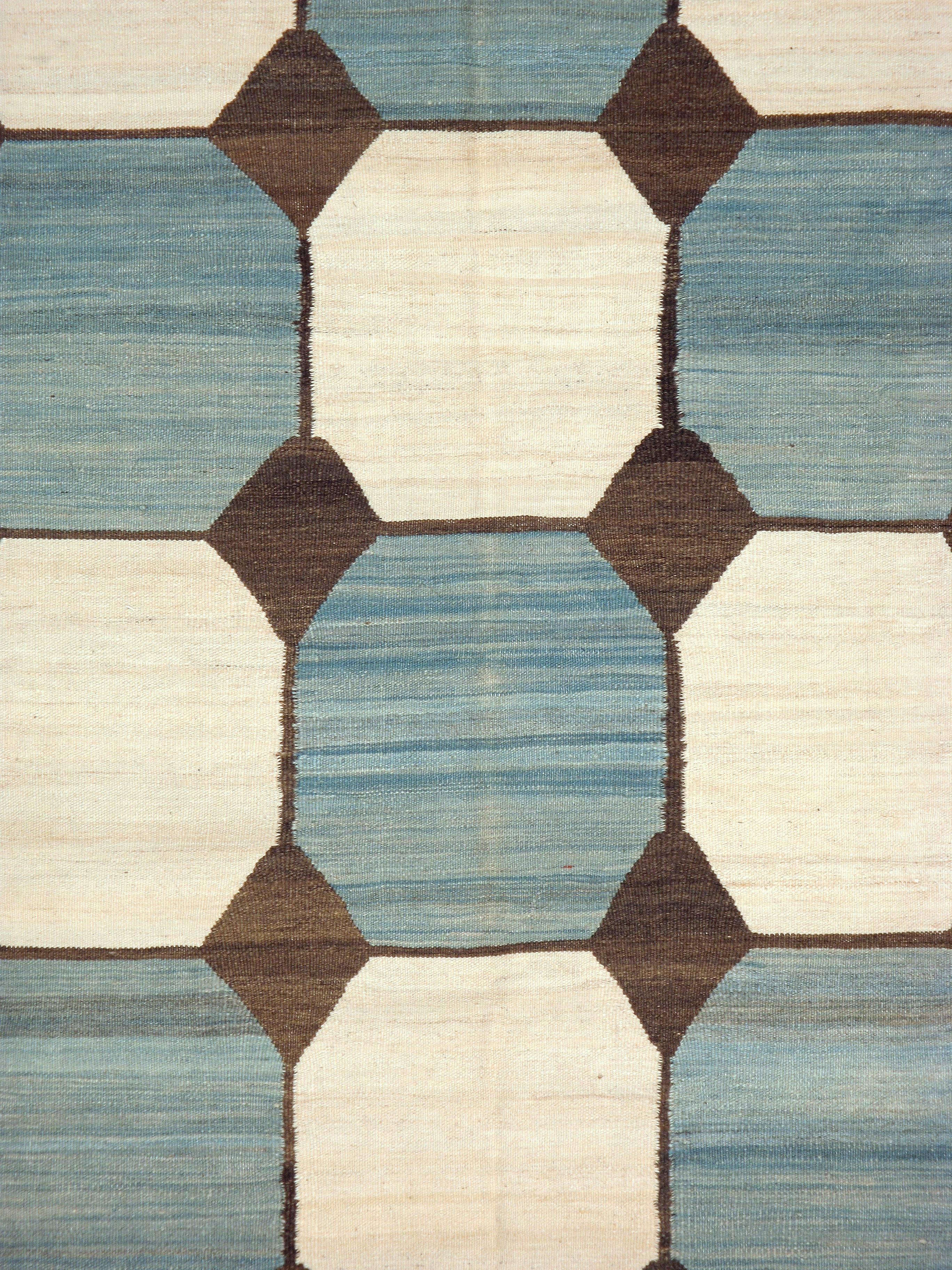 A Persian modernist flat-weave from the fourth quarter of the 20th century in the style of Indian Dhurrie rugs and a weave found on Swedish and Scandinavian modern Kilims.

Measures: 10' 0