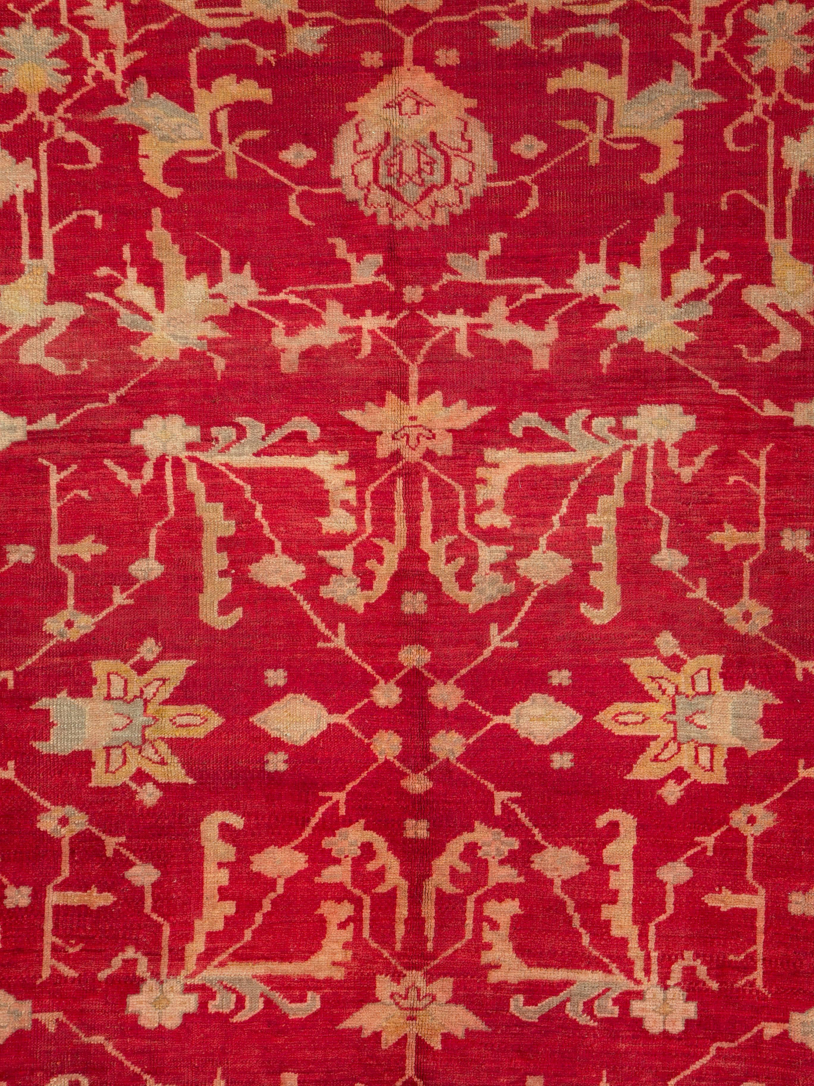 An antique Turkish Oushak room size carpet in square format handmade during the early 20th century with a bright red field and a slate grey wide border.

Measures: 10' 2