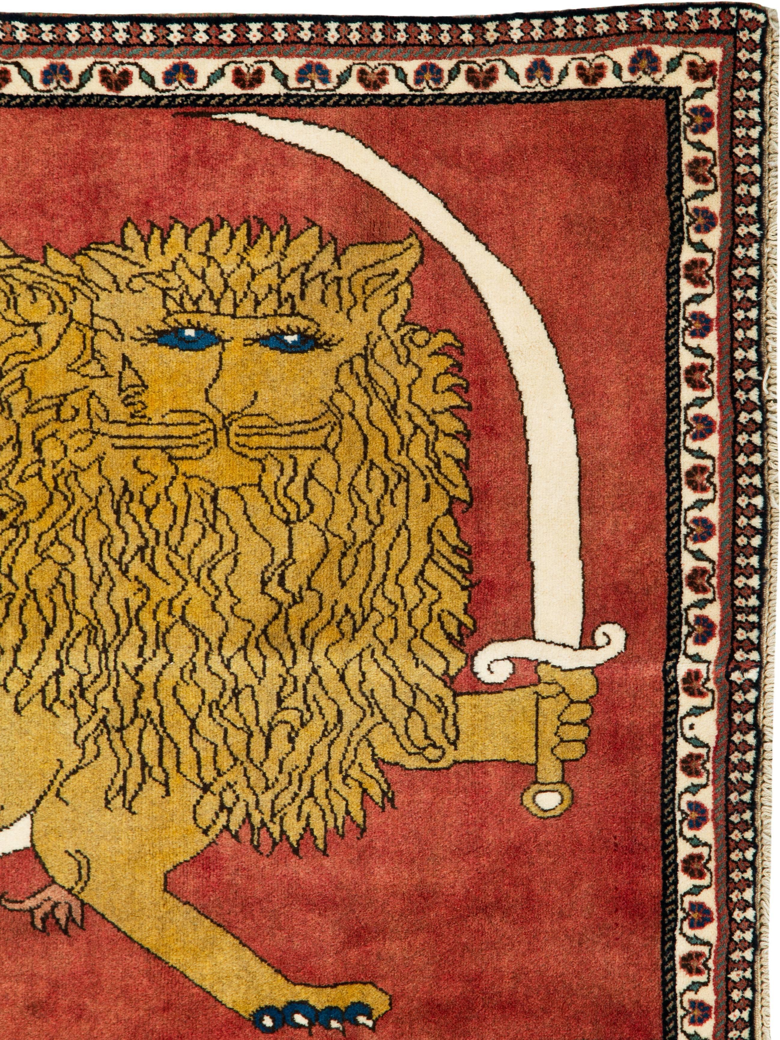 A vintage Persian Shiraz rug from the late 20th century displaying the lion and sun symbol.