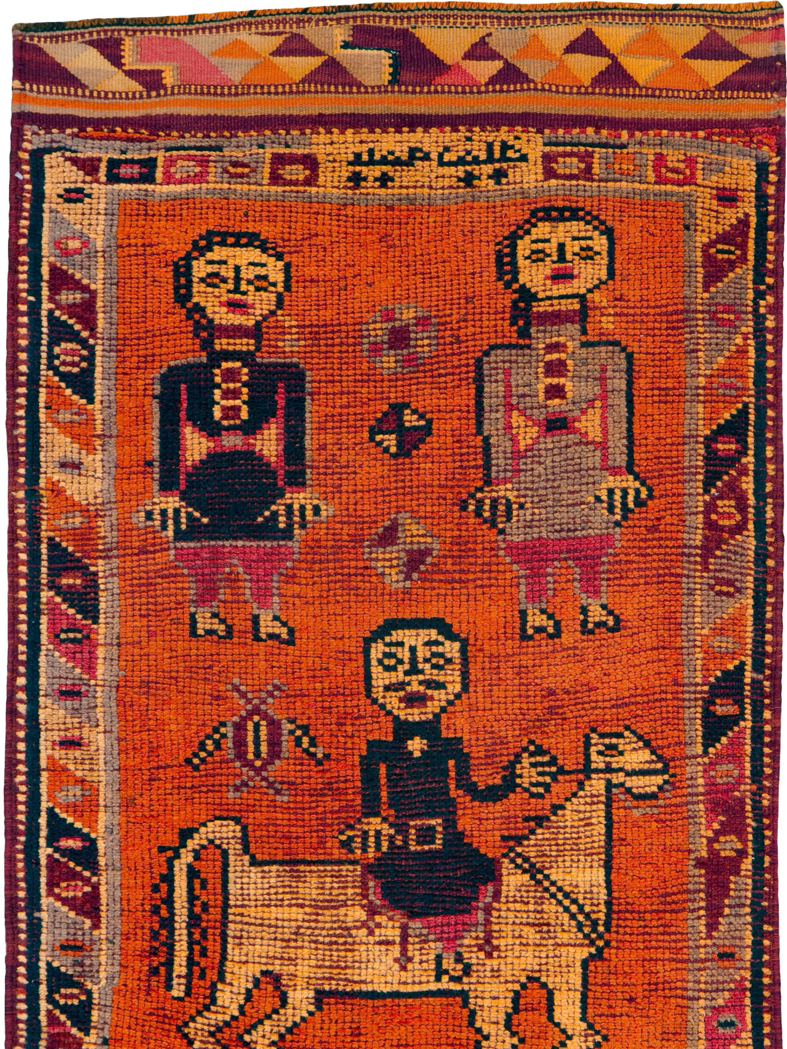 A vintage Turkish Anatolian rug, with a pictorial design and Kilim (flat-weave) ends, from the mid-20th century.

Measures: 2' 11