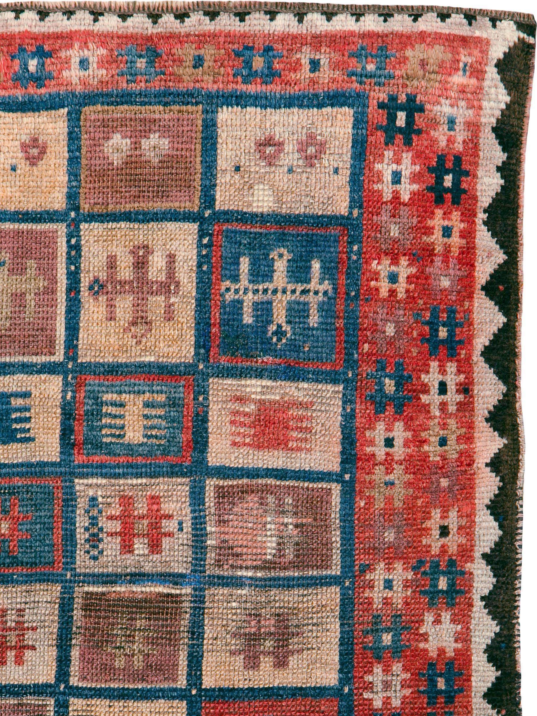 An antique Persian Gabbeh rug from the early 20th century.

Measures: 2' 9