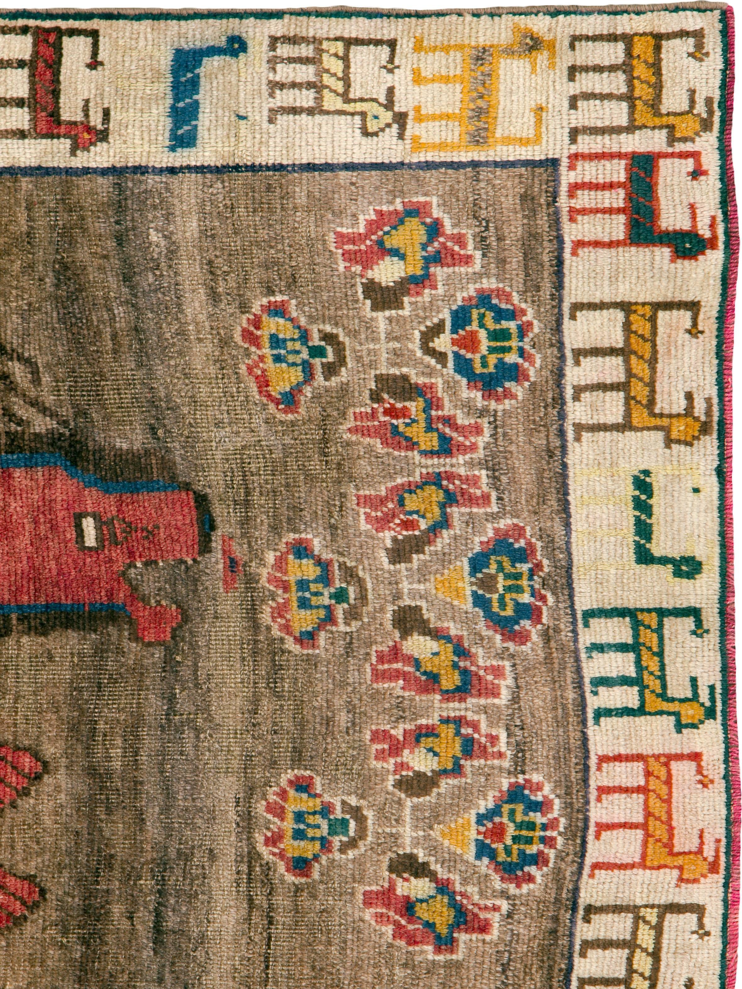 A vintage Persian Gabbeh rug from the mid-20th century with a pictorial design.