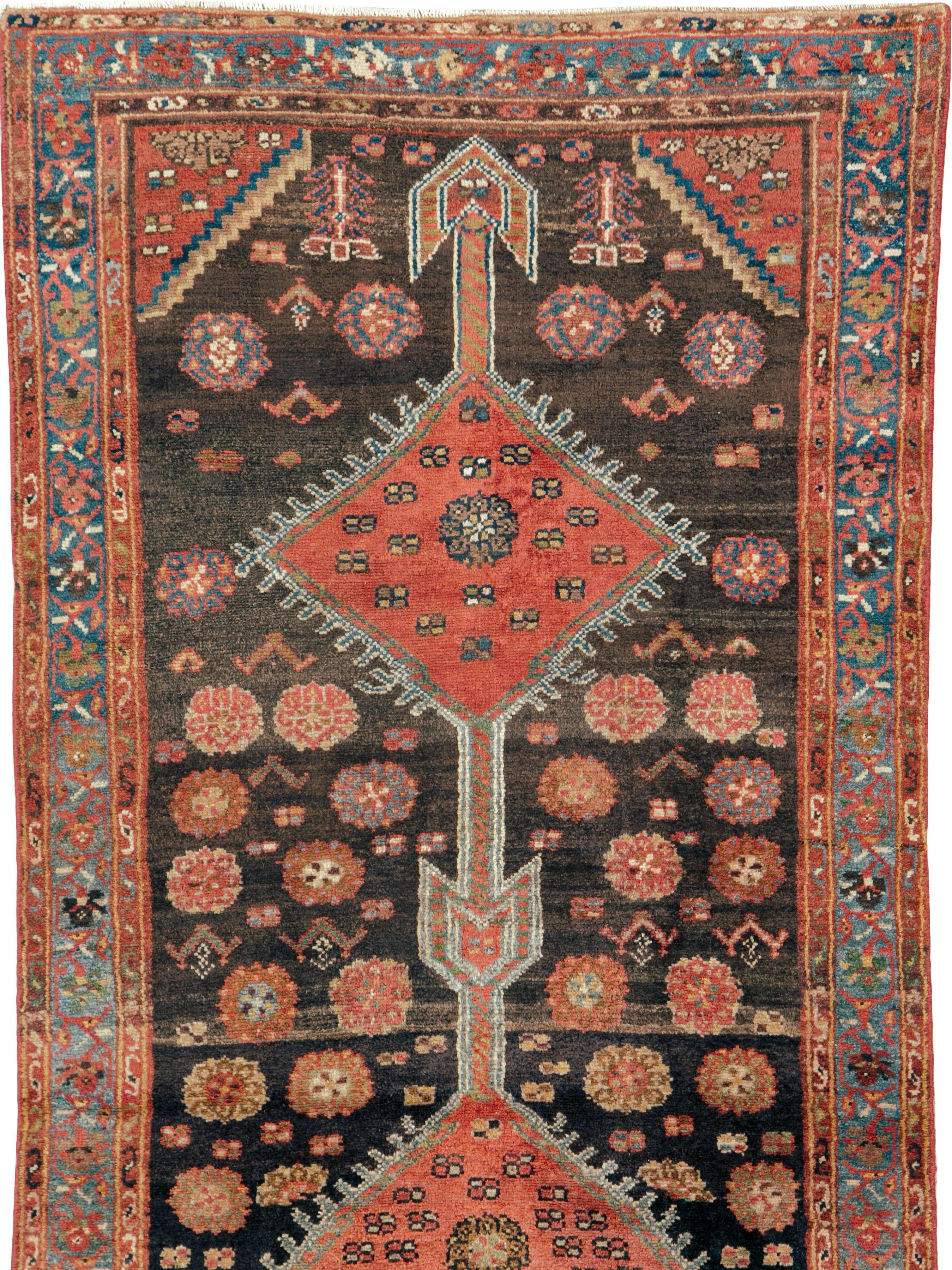 An antique Persian Kurd rug from the early 20th century.