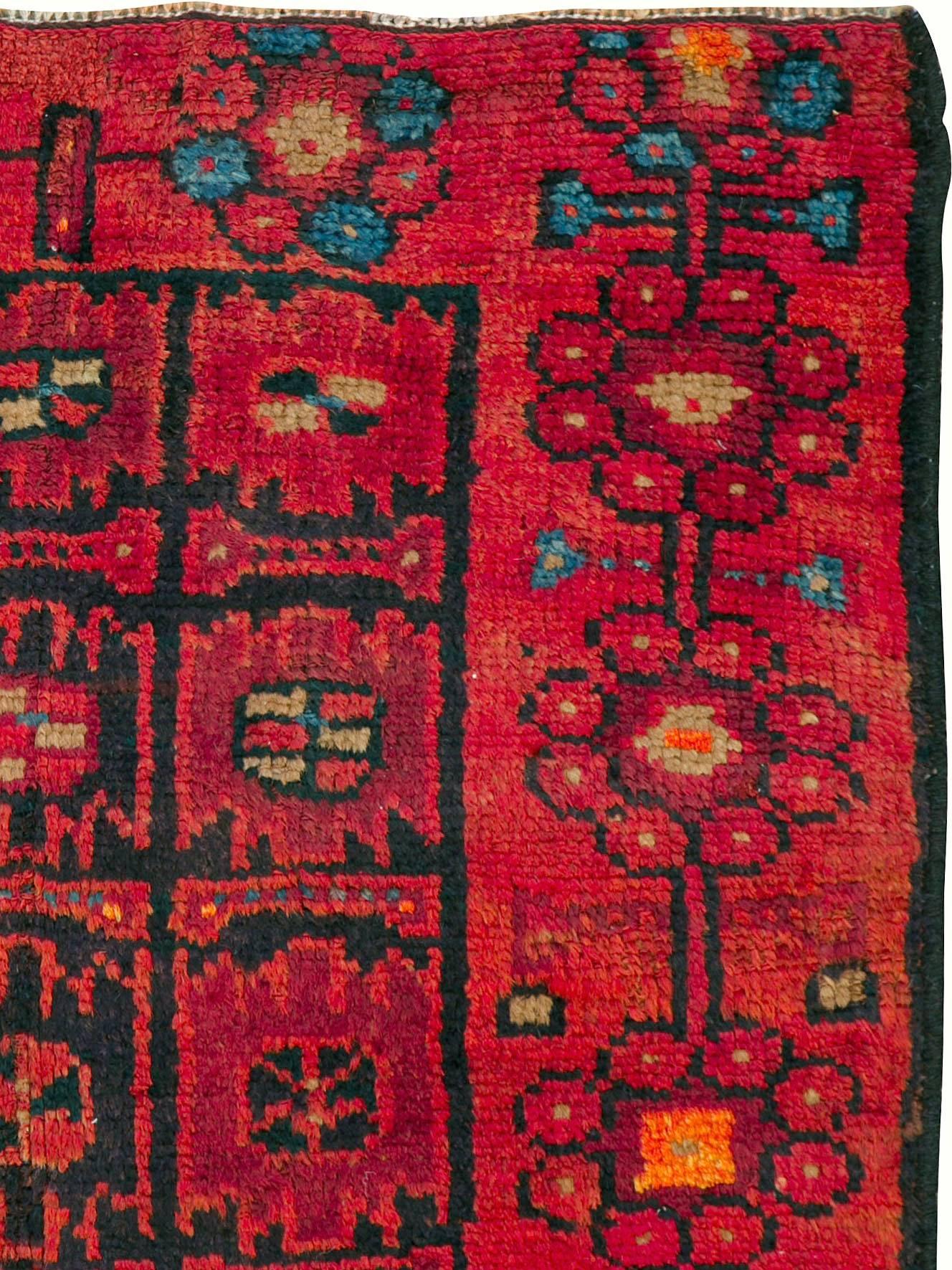 A vintage Persian Kurd rug from the mid-20th century.