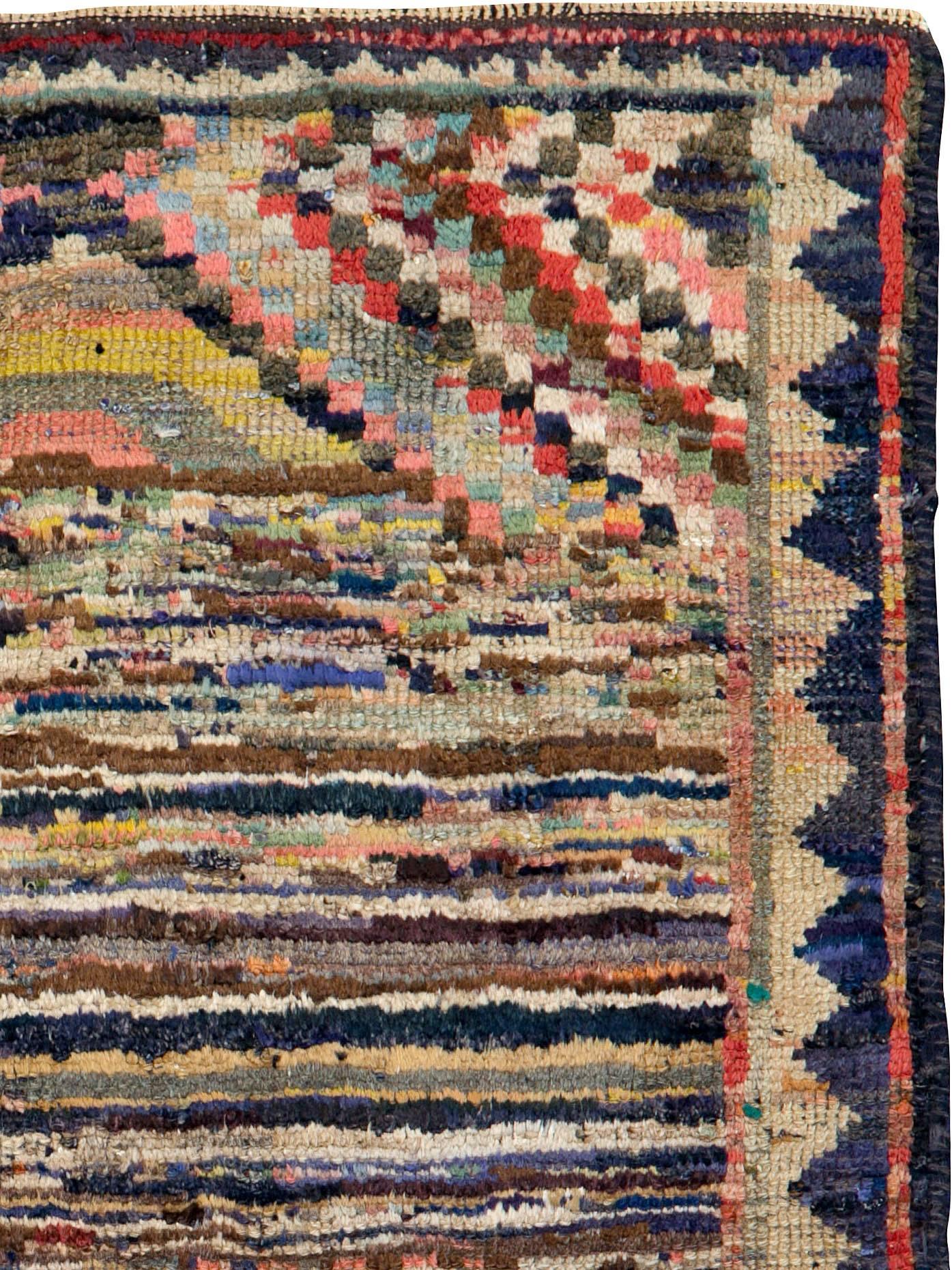 An antique Persian Gabbeh rug from the early 20th century.