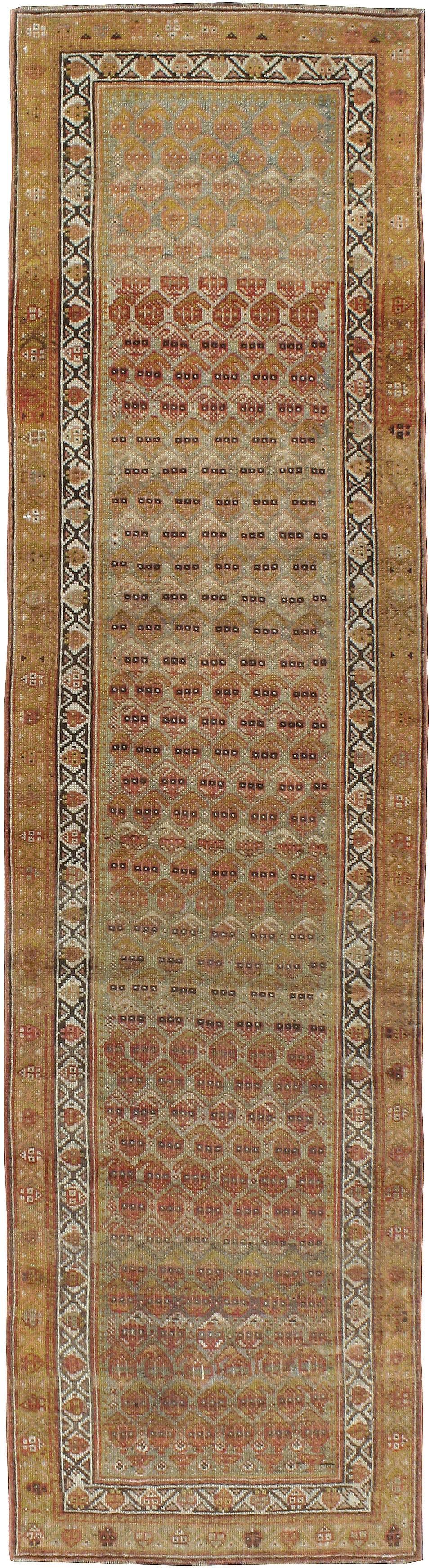 An antique Persian Malayer rug from the first quarter of the 20th century. Malayer is one of over 100 weaving villages outside of Hamadan in Northwestern Iran. The patterns of Malayer rugs are primarily geometric and one Classic pattern, ‘boteh’