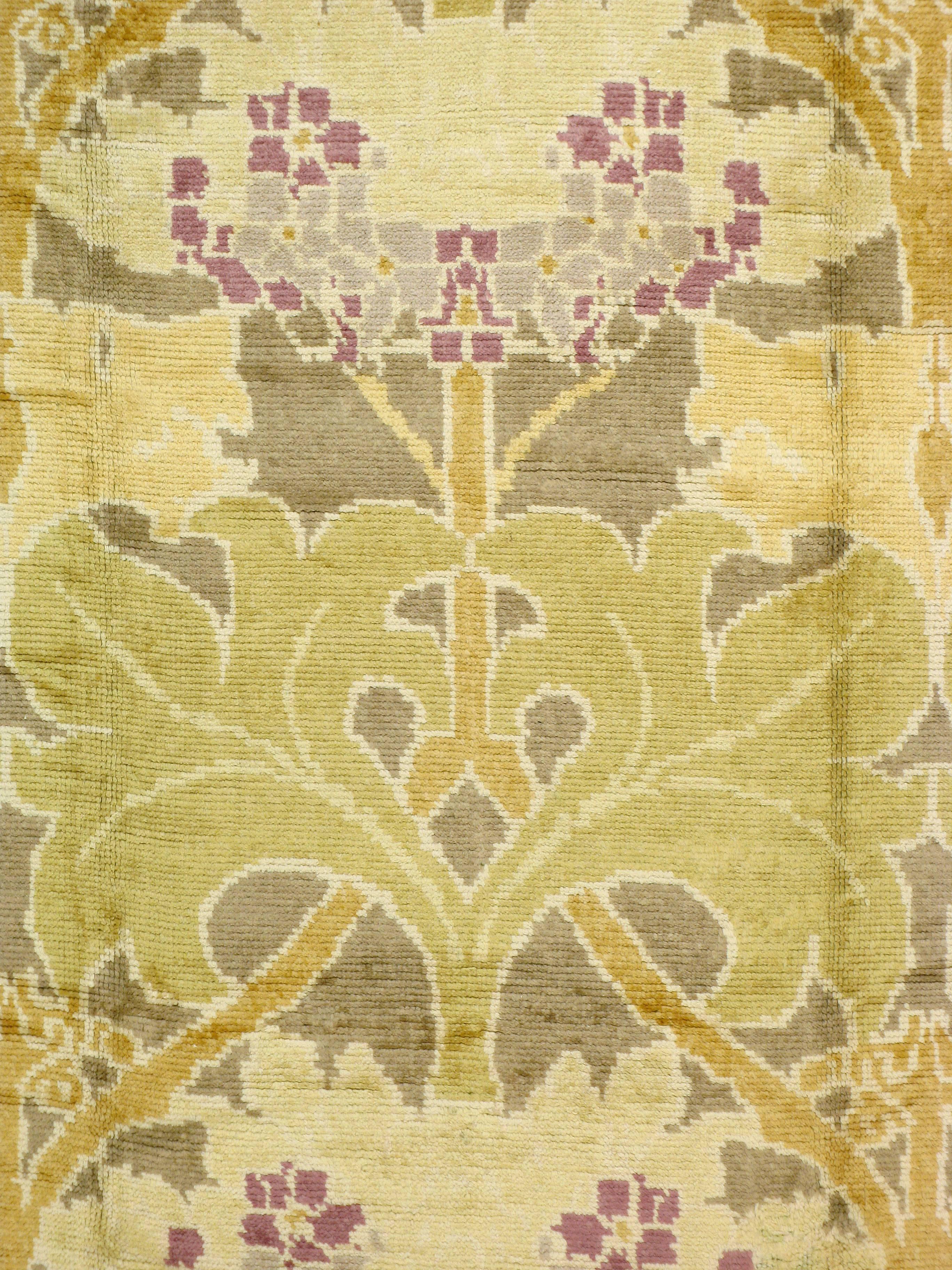 A vintage English Donegal carpet in the style of Donnemara created by architecturally trained designer C.F.A Voysey whom was influenced by a fusion of the Arts and Craft Movement and Art Nouveau, and William Morris designs. Donnemara is considered
