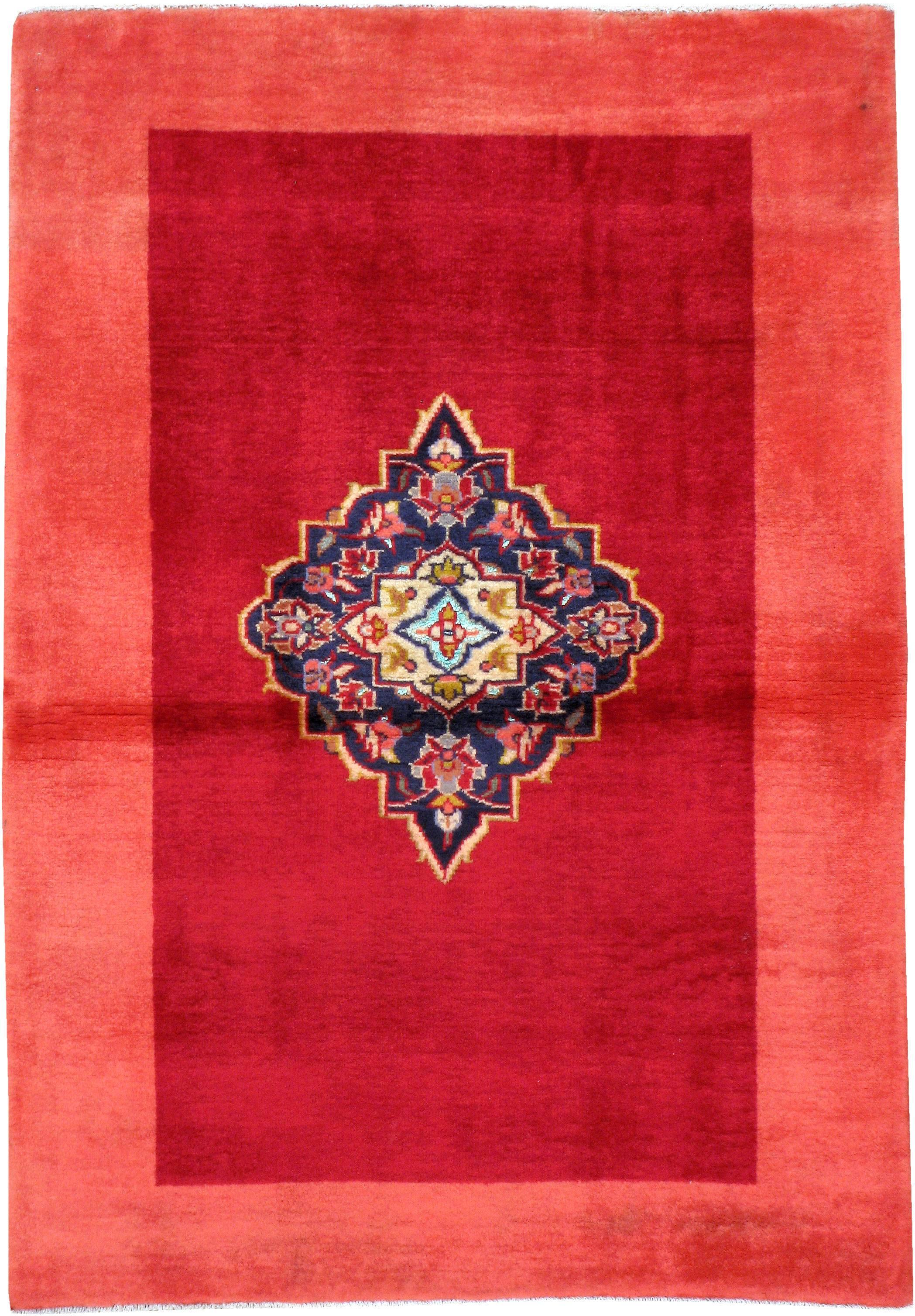 A vintage Persian Kashan carpet from the second quarter of the 20th century. A traditional navy blue Herati medallion serves as the focal point and contrasts over a monochromatic modern style madder red field and border.