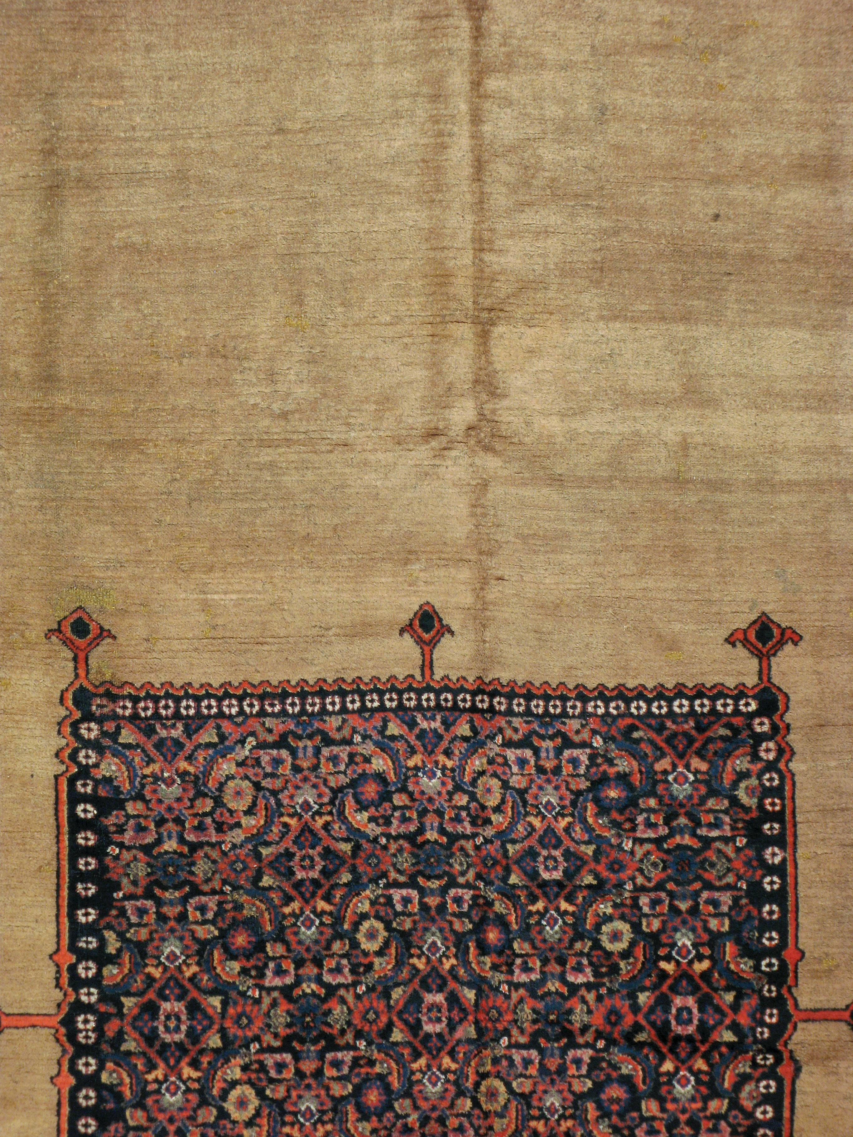 An antique Persian Dorokhsh carpet from the late 19th century. The carpet consists of several motifs, such as a border with a 