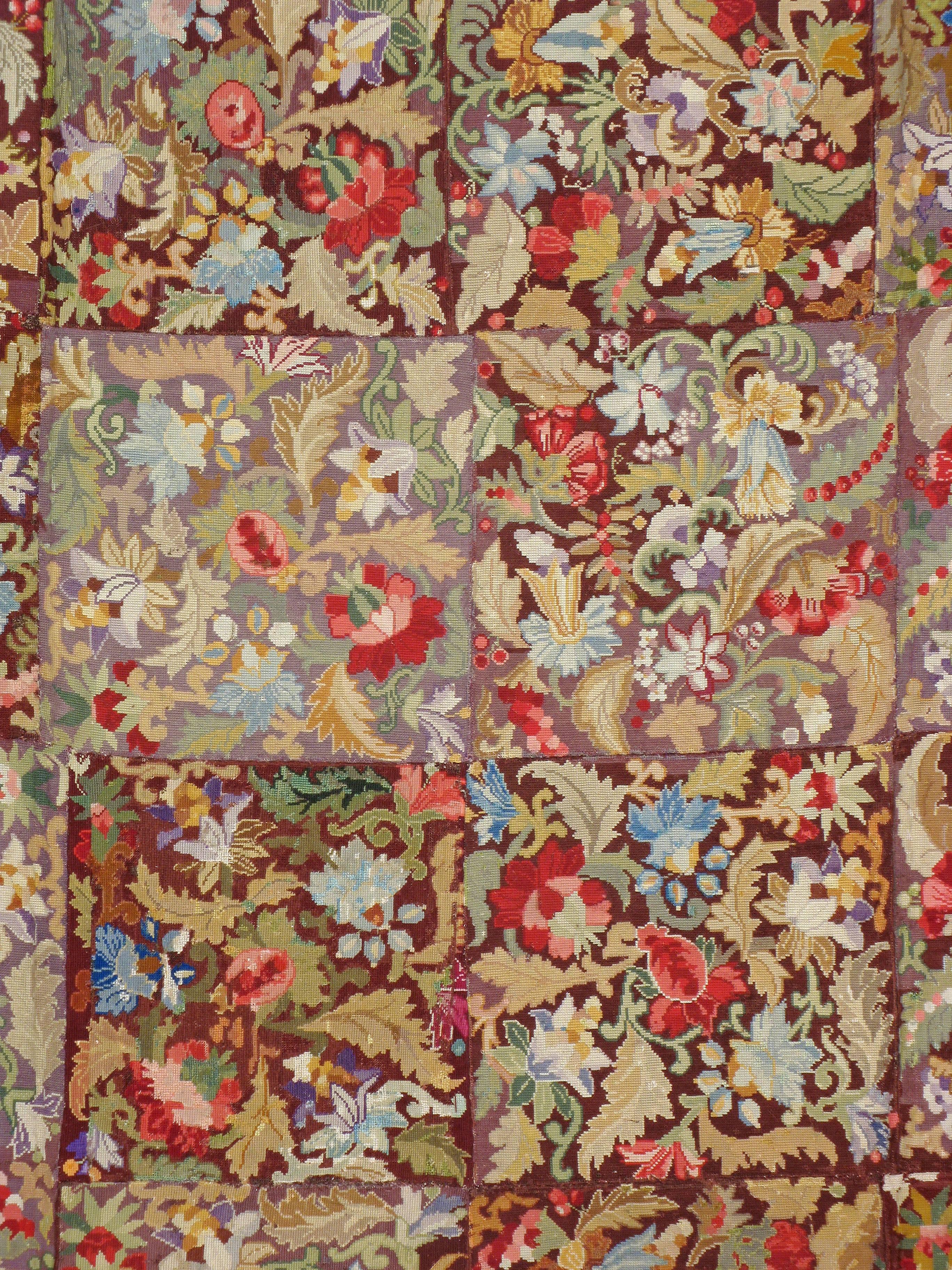 An antique English needlepoint carpet from the first quarter of the 20th century.

Measures: 9' 10