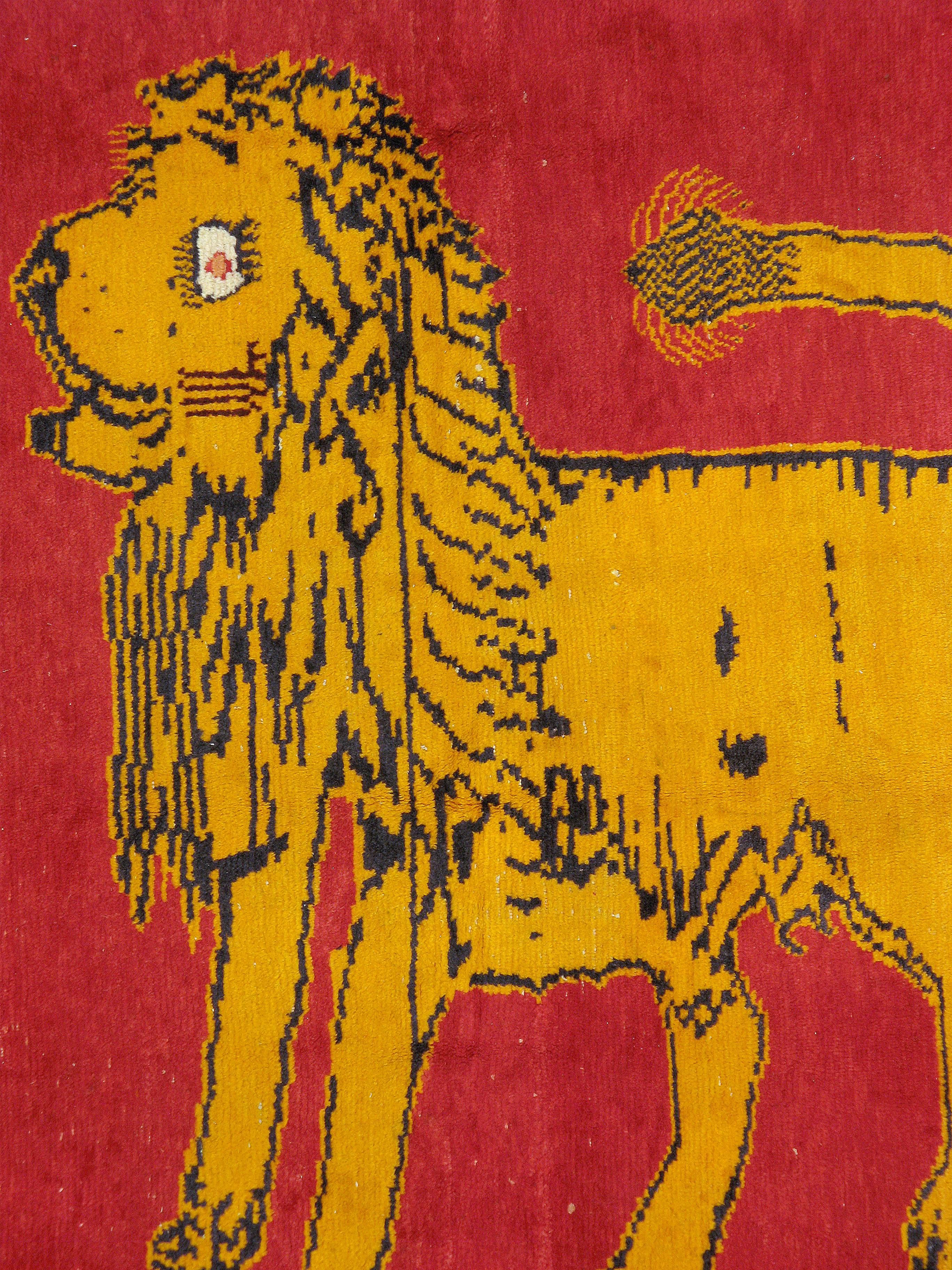 A vintage Persian Gabbeh carpet with a pictorial design of two lions from the mid-20th century.