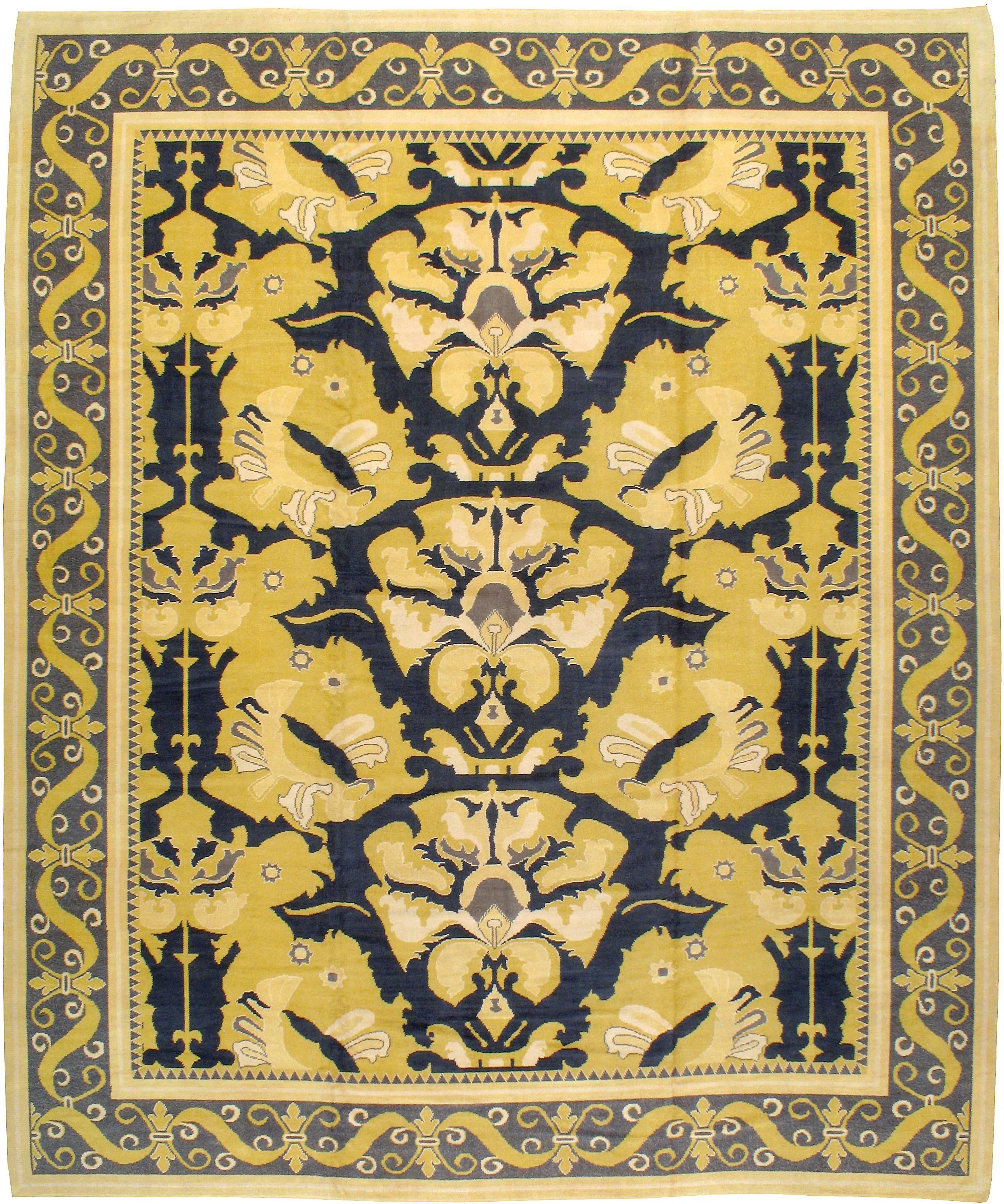 A vintage Spanish Cuenca carpet, from the mid-20th century, reminiscent of the Arts & Crafts movement and executed in midnight blue and saffron.

Measures: 11' 10