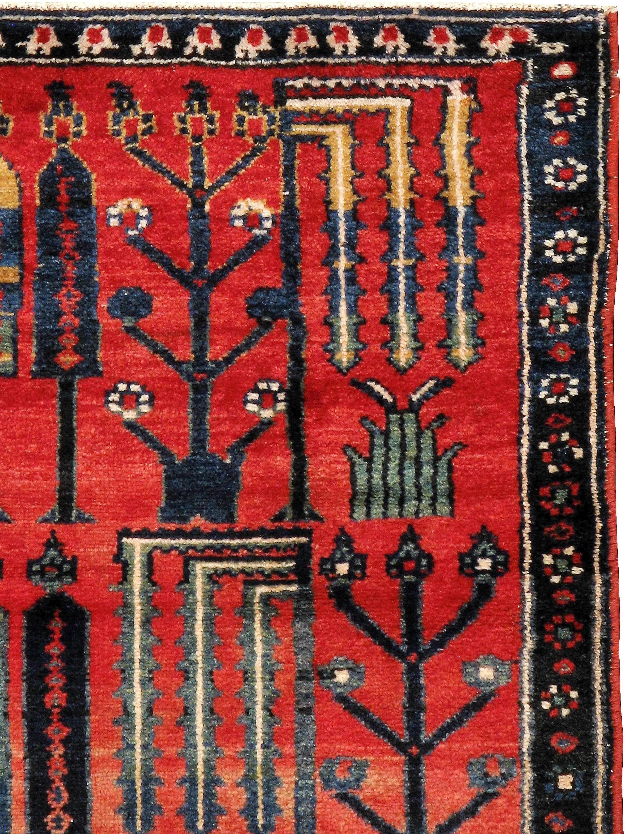 An antique Persian Bakhtiari carpet from the second quarter of the 20th century.