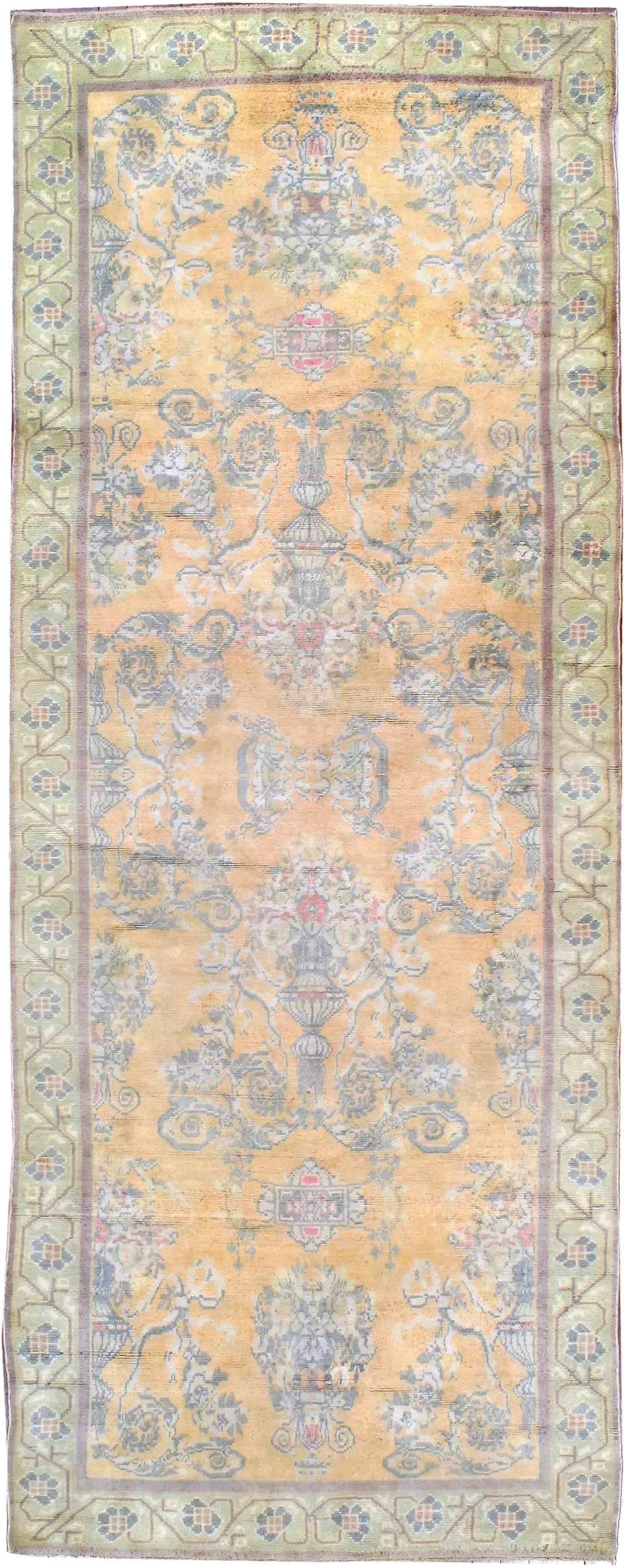 A vintage Indian Cotton Agra carpet from the second quarter of the 20th century featuring a floral and vine pattern on an apricot field.