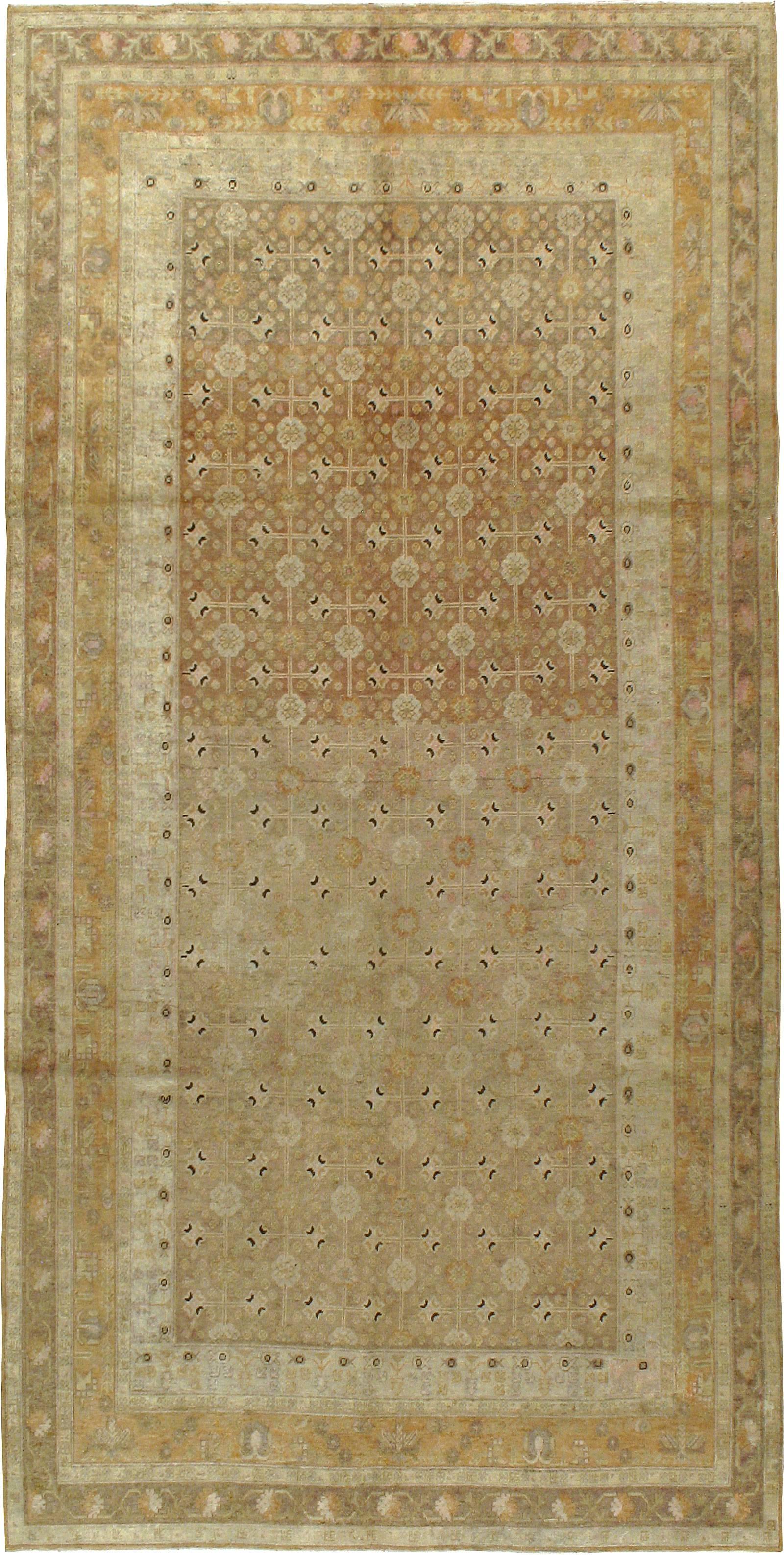 An antique East Turkestan Khotan carpet from the first quarter of the 20th century. Antique Khotan rugs and carpets were produced in the oasis town of Eastern Turkestan, today part of the Xinjiang region in Western China. This area has had a steady
