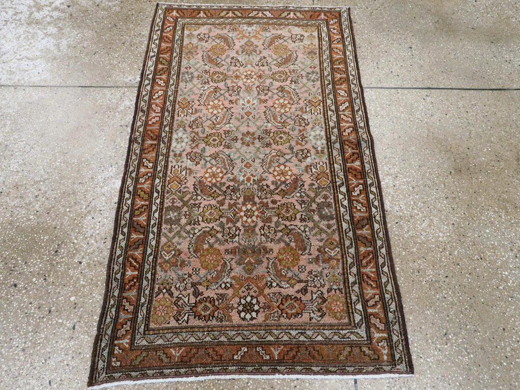 Un tappeto persiano vintage Malayer. Rosette avorio e dorate spiccano in questo piccolo spargimento di Malayer con un motivo Herati allover su un campo marrone, all'interno di un bordo rosso-marrone con foglie oblique seghettate e fiori a forma di