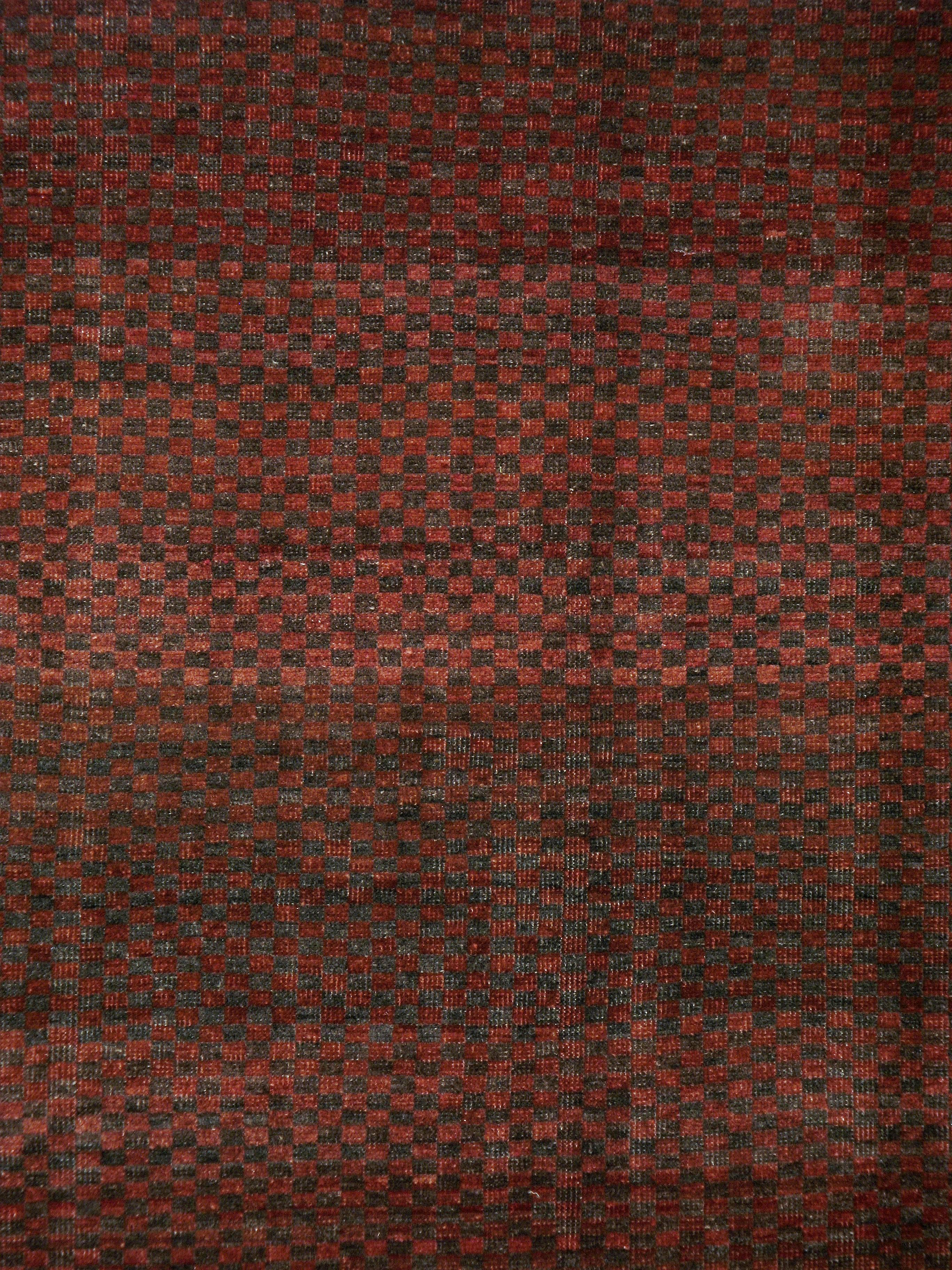 A vintage Turkish Anatolian carpet from the second quarter of the 20th century with a checkerboard pattern in maroon and chocolate.