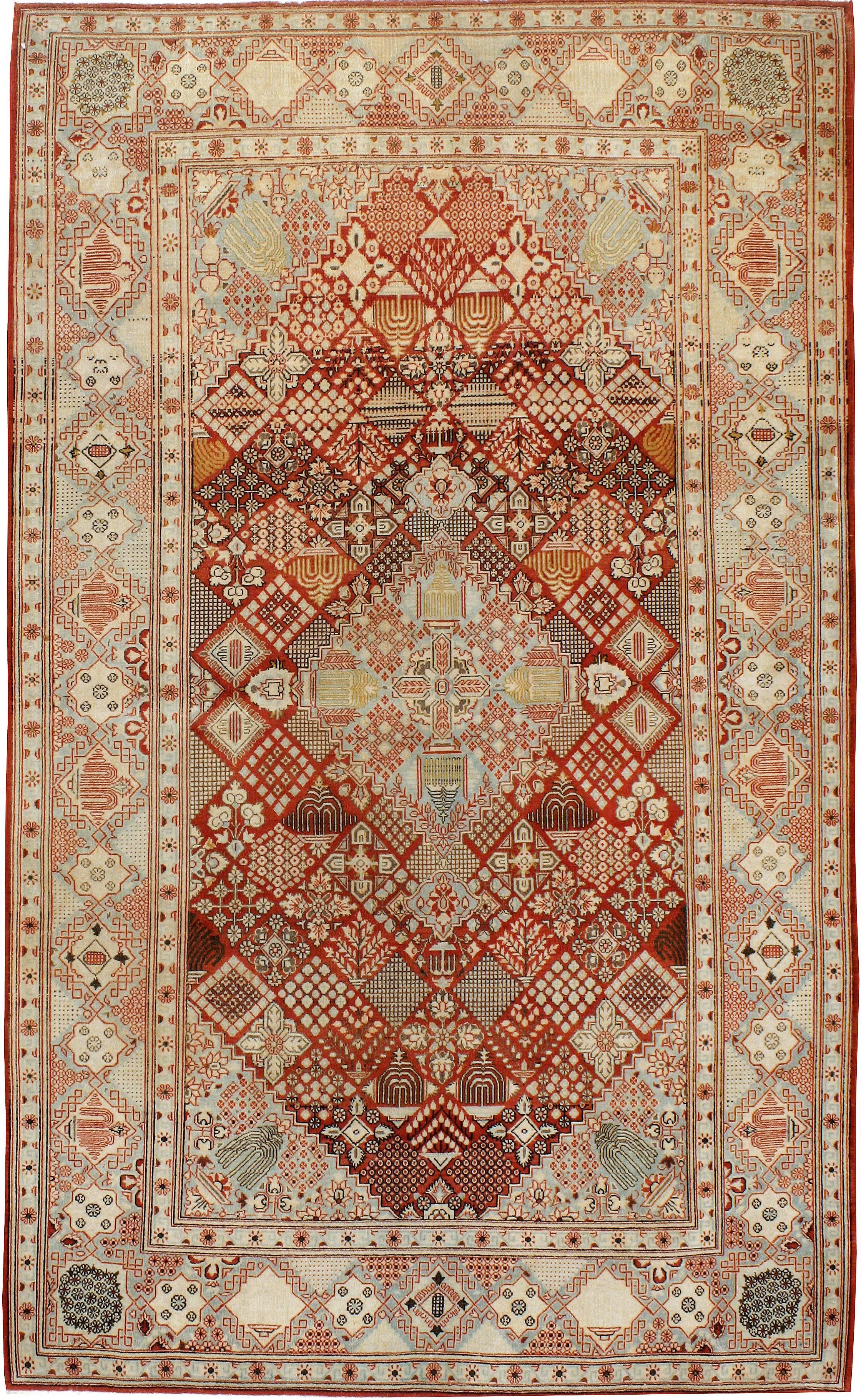 An antique Persian Kashan carpet from the second quarter of the 20th century featuring a Joshegan pattern; colors consisting of brick and slate.