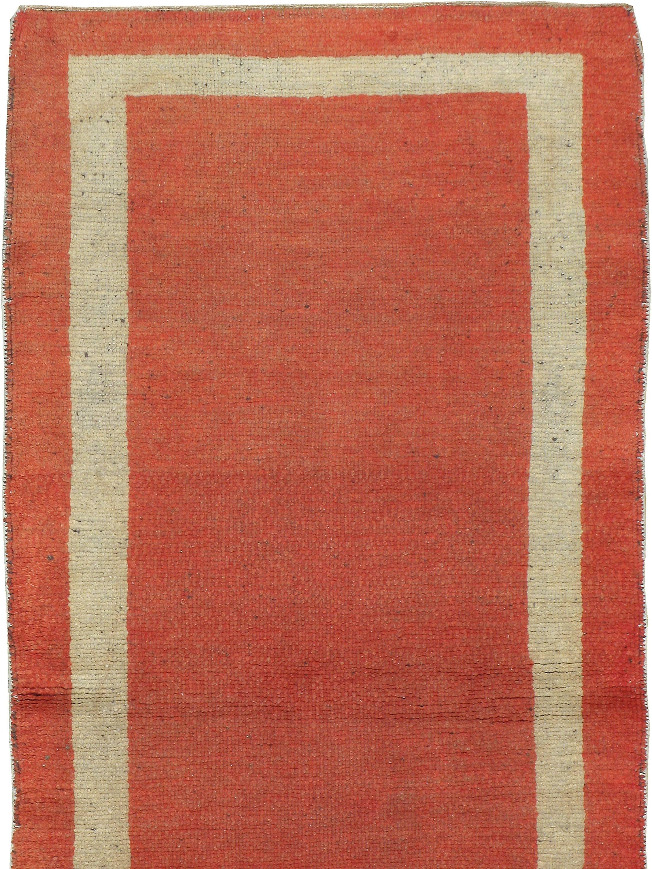 Ein alter türkischer Oushak-Teppich aus dem zweiten Viertel des 20. Jahrhunderts mit einem minimalistischen, einfarbig orangefarbenen Grund, der von einer einzigen Bordüre umgeben ist.