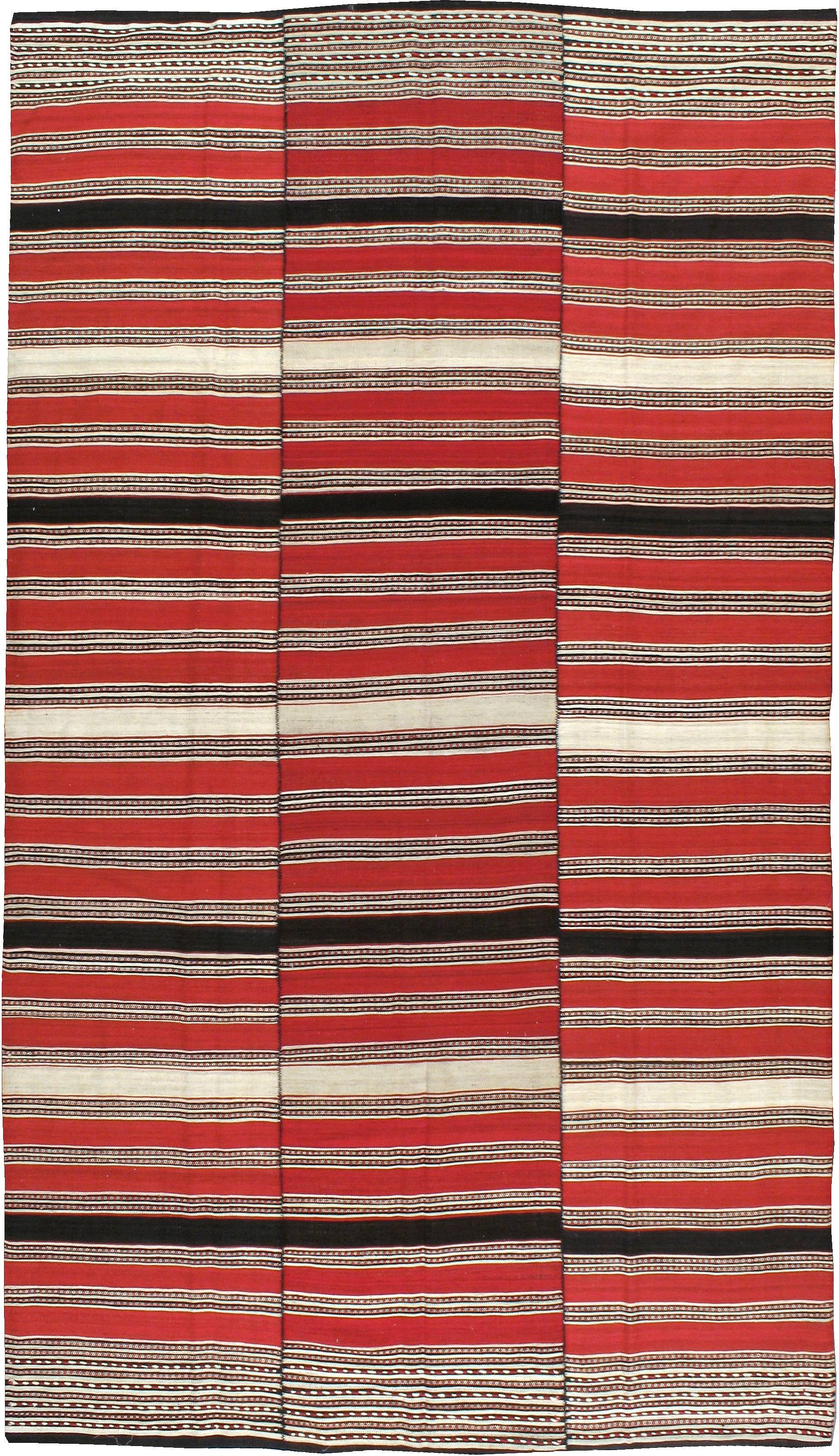 A vintage Persian flat-woven Kilim rug from the mid-20th century.