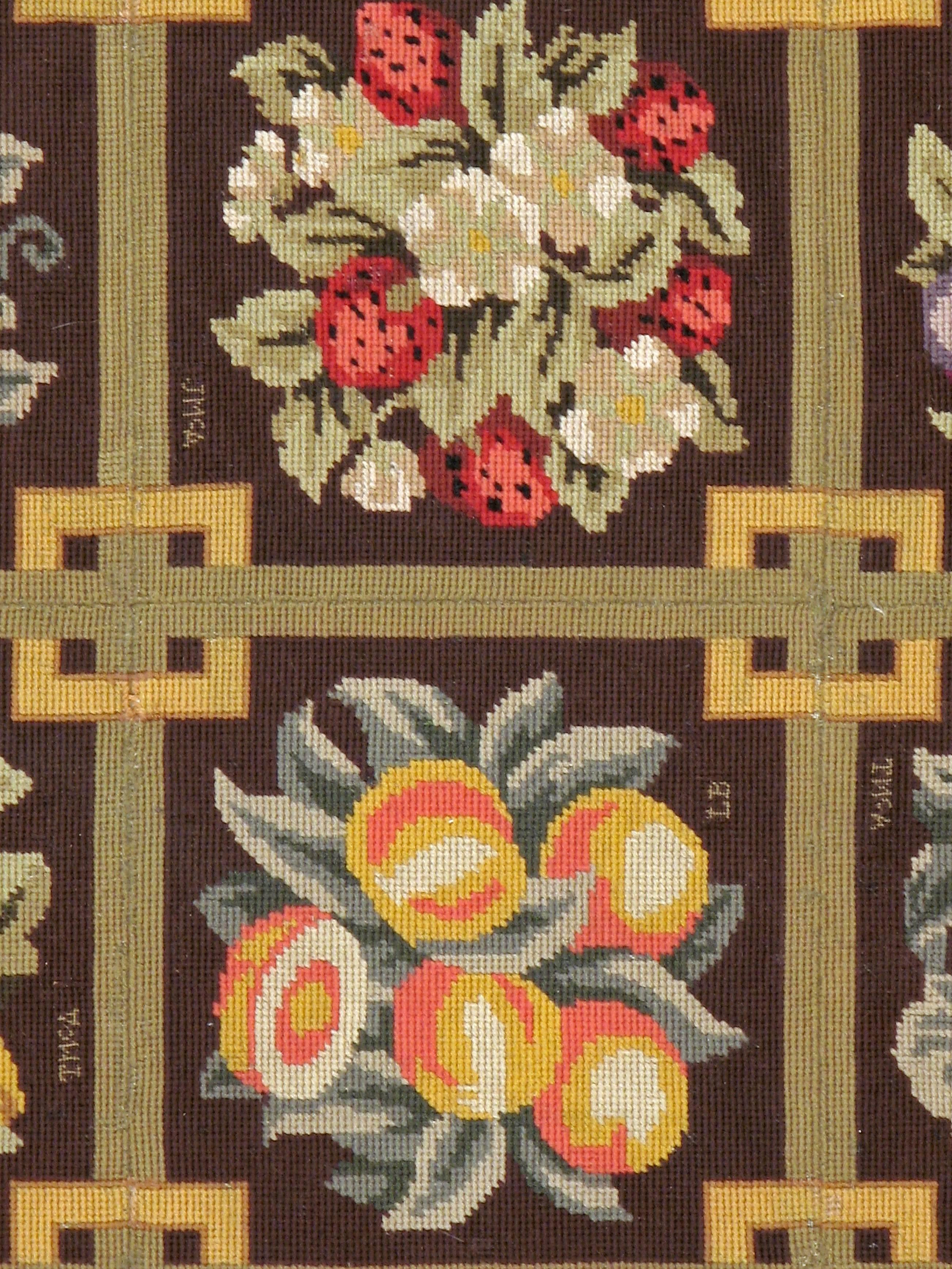 A vintage English needlepoint carpet from the mid-20th century.