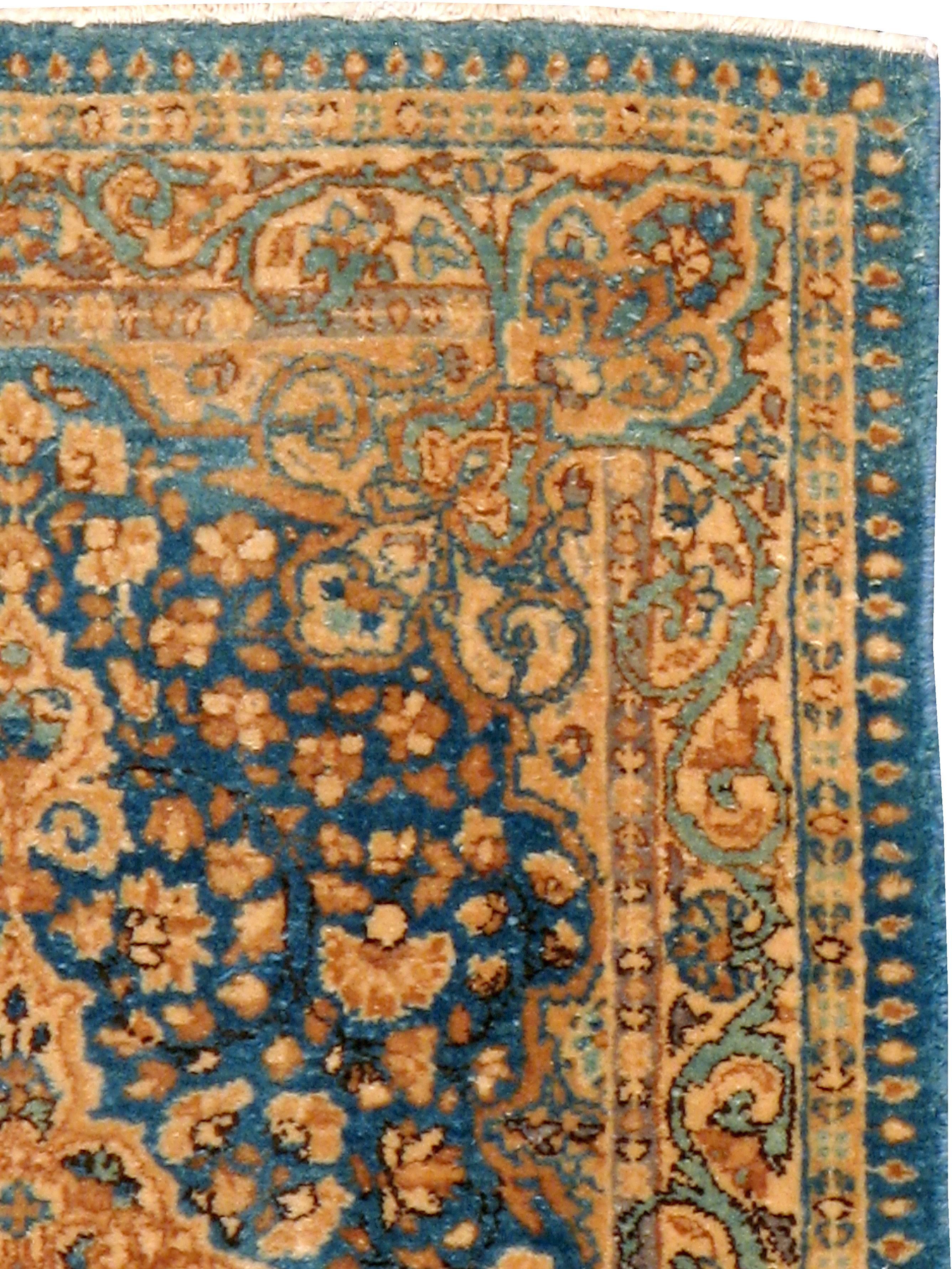 A vintage Persian Kerman rug from the mid-20th century.