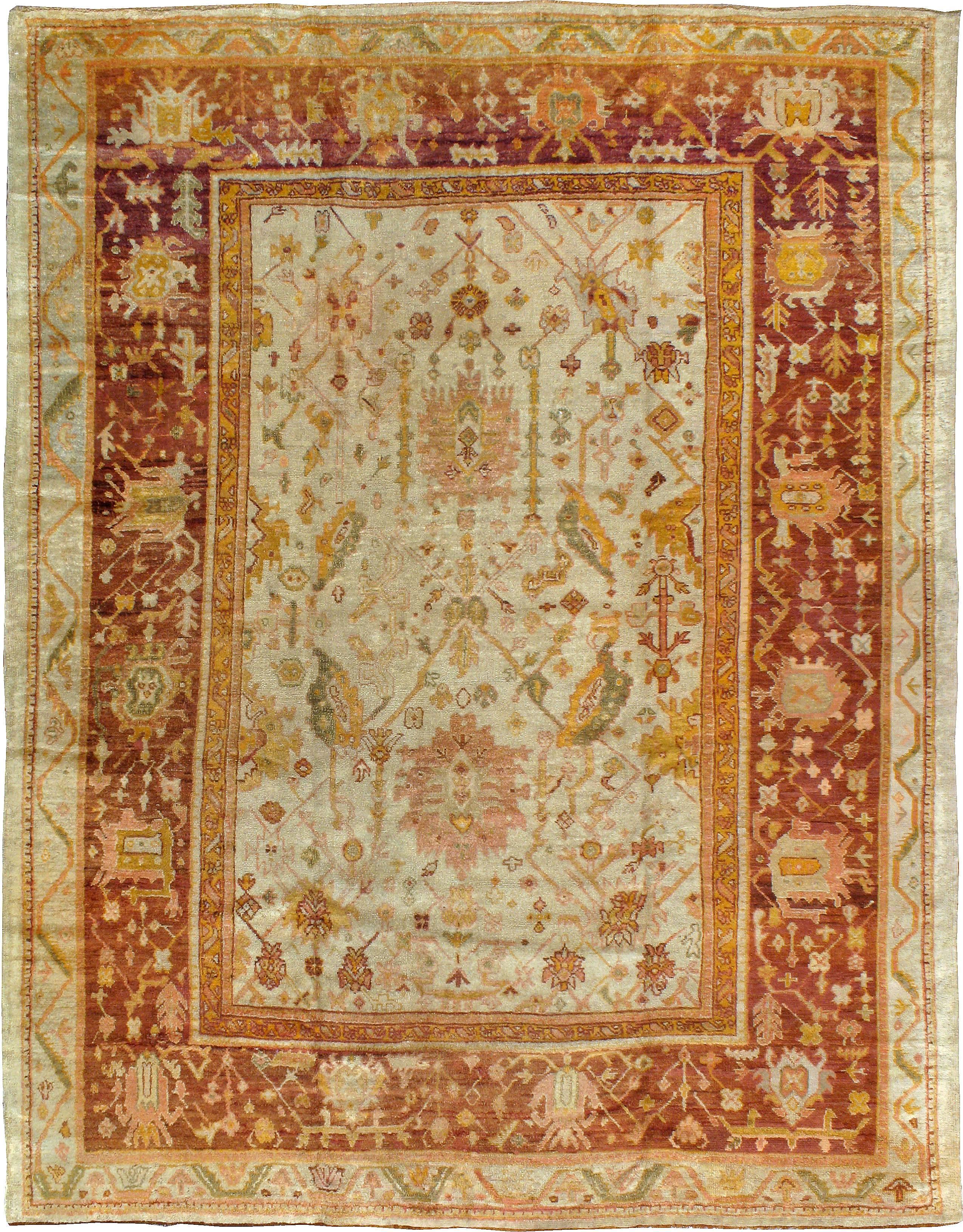 An antique Turkish Oushak carpet from the turn of the 20th century. It's revering life has sublimely given it a vintage look and patina.