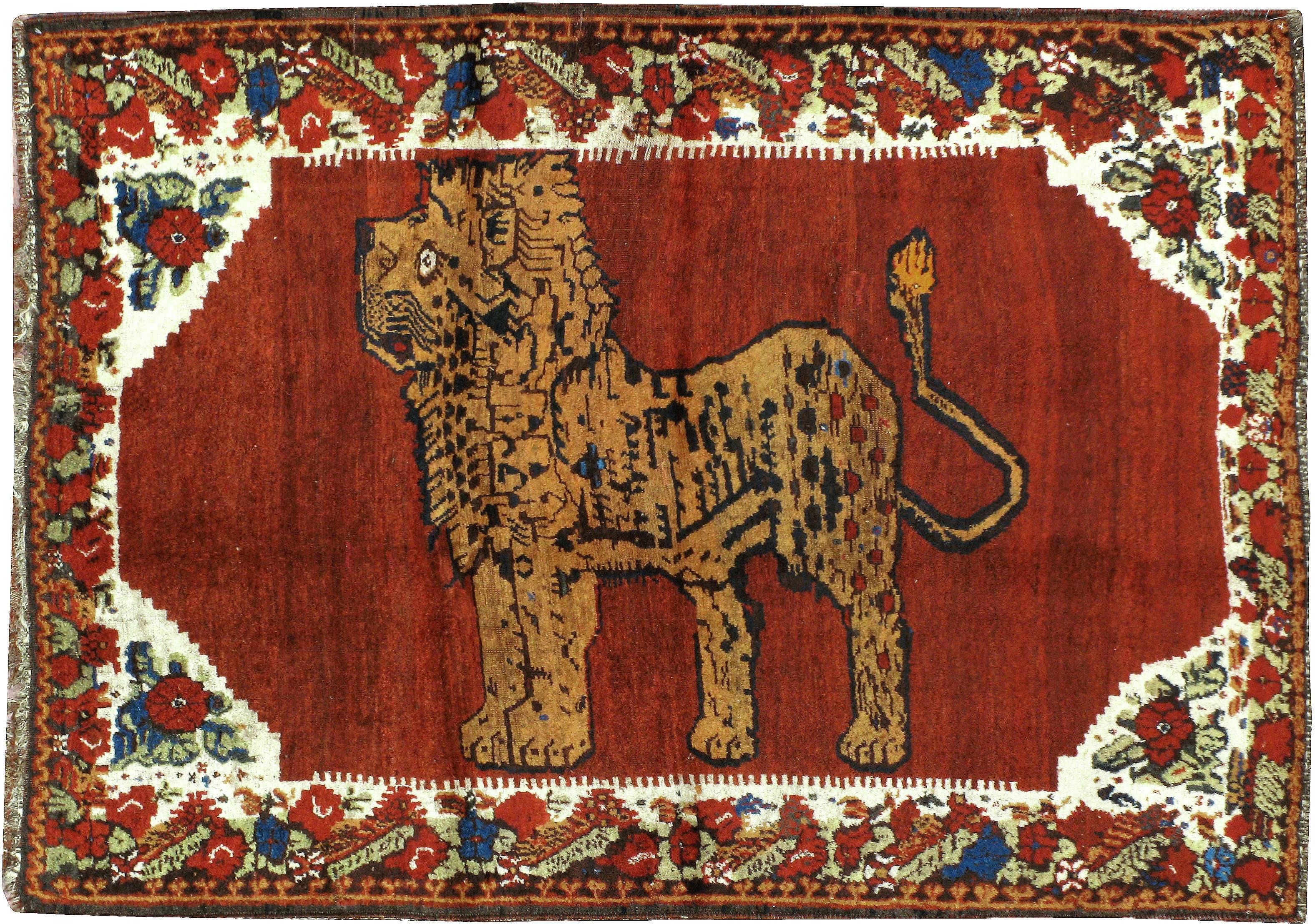 An antique Persian Gabbeh carpet from the first quarter of the 20th century featuring a pictorial design of a lion.

Measures: 4' 4